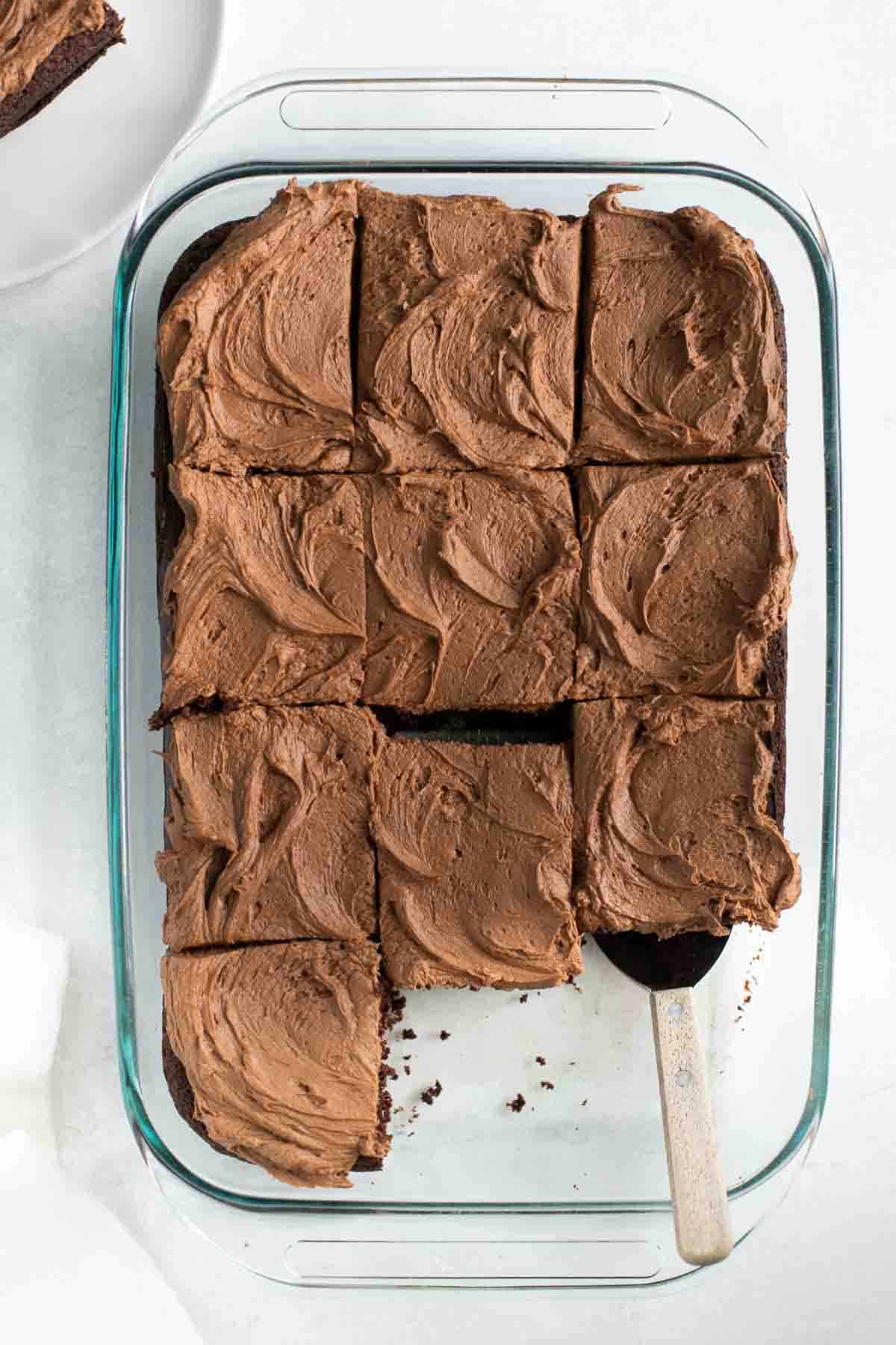 gluten free chocolate sheet cake in glass baking dish topped with chocolate frosting