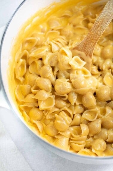 close up image of gluten free mac and cheese in white dutch oven