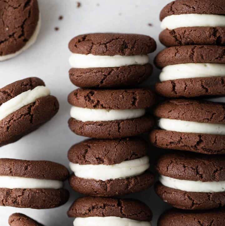 gluten free oreo cookies with cream filling stacked in rows on white background