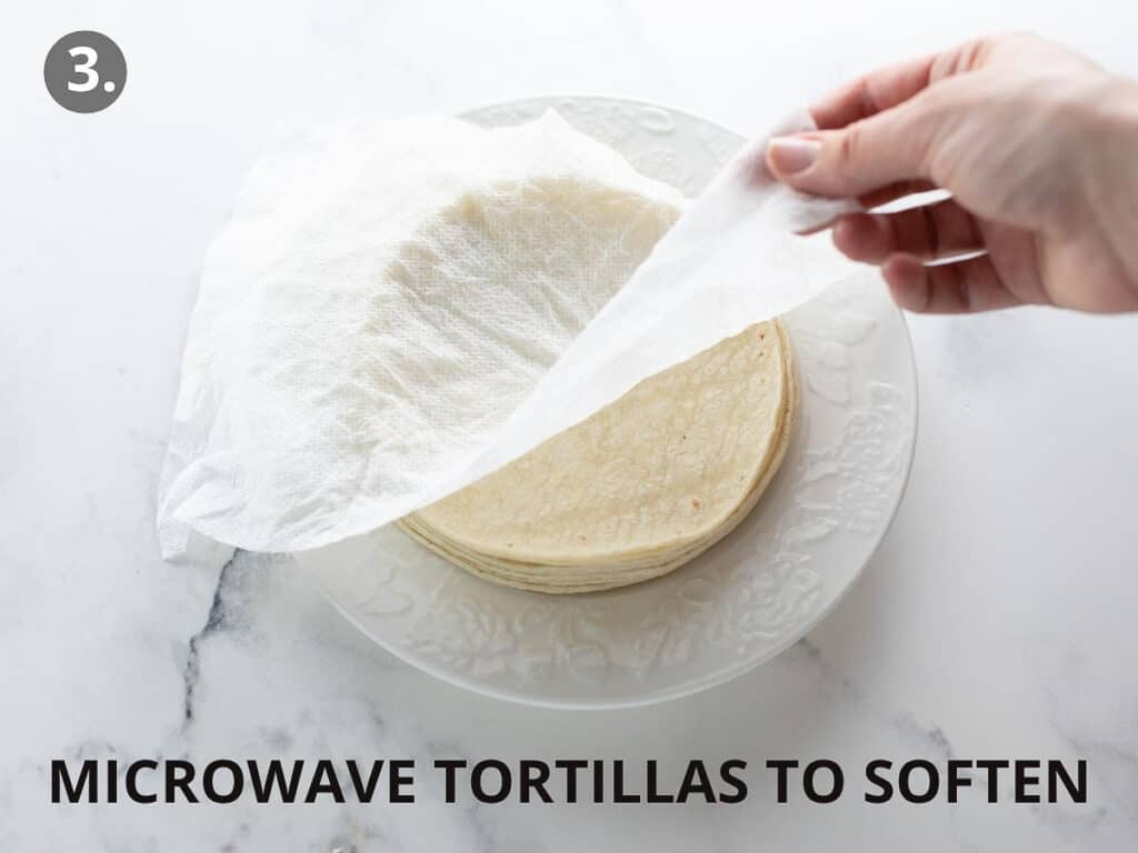 tortillas on white plate being softened in the microwave