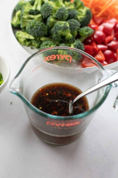 stir fry sauce whisked together in glass measuring cup