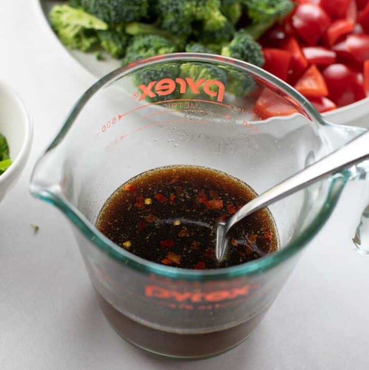 stir fry sauce whisked together in glass measuring cup