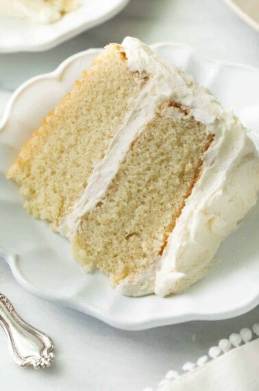 slice of gluten free vanilla cake on white plate
