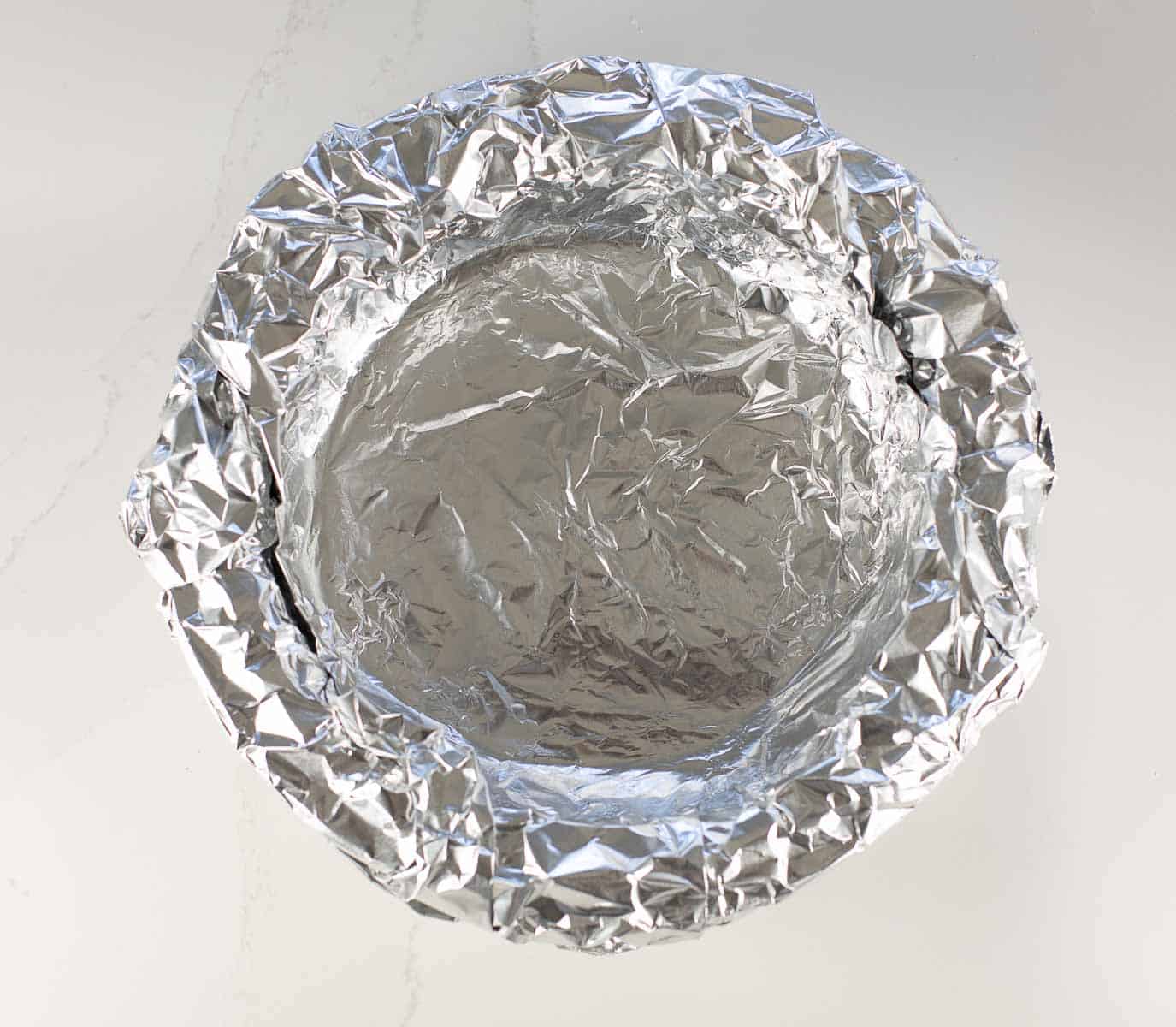 pie crust covered in foil before par-baking