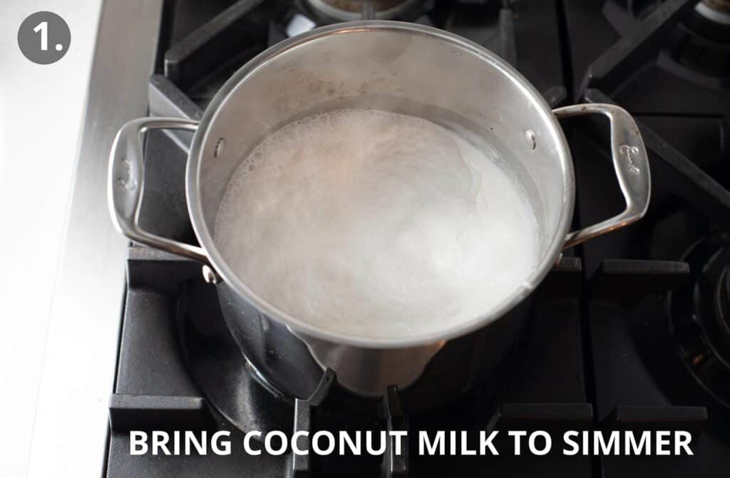 coconut milk in metal pot being brought to a simmer
