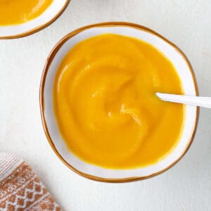 overhead shot of butternut squash soup in bowl with spoon