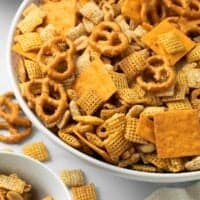 close up image of gluten free chex mix in white bowl