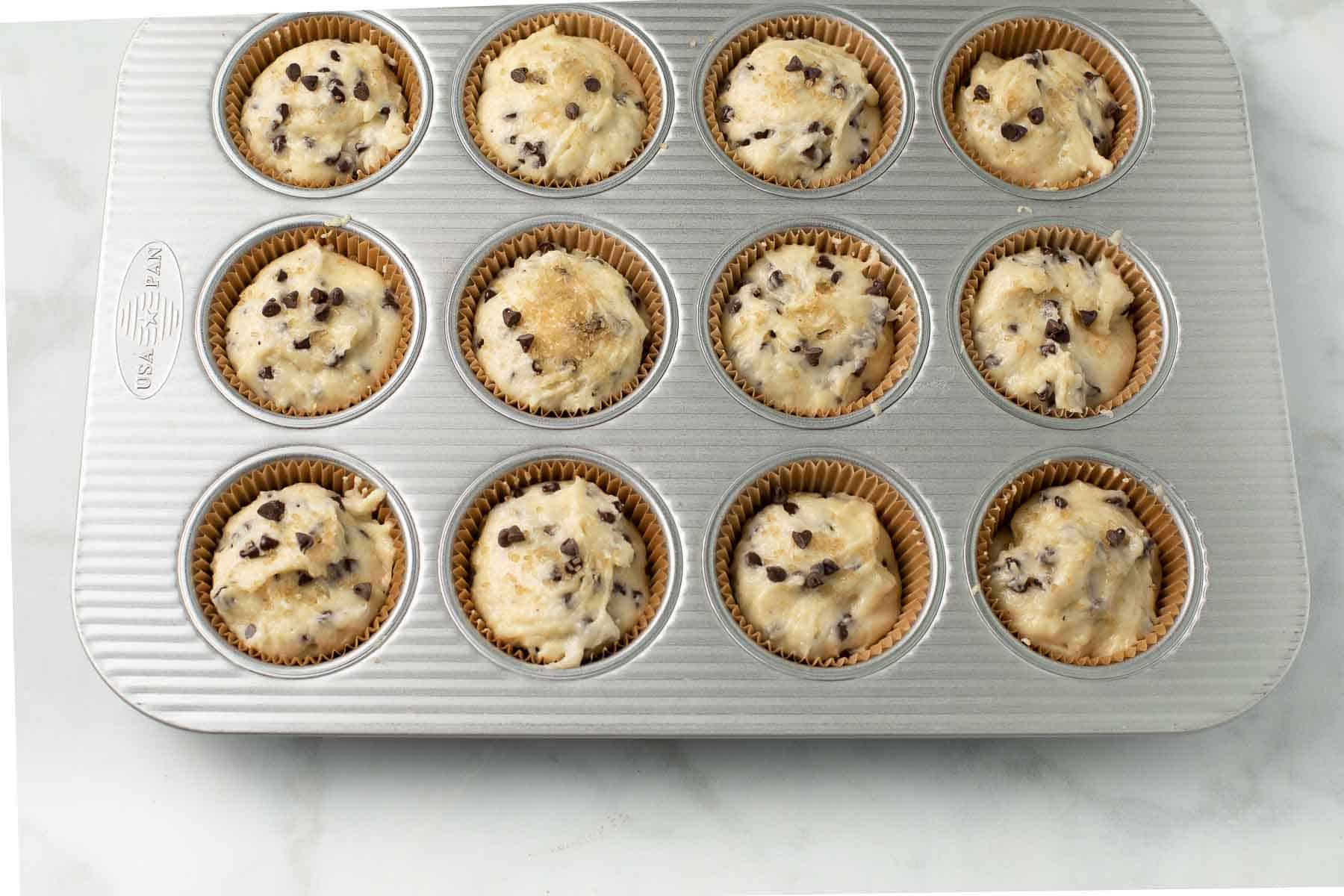 chocolate chip muffin batter in the muffin tin