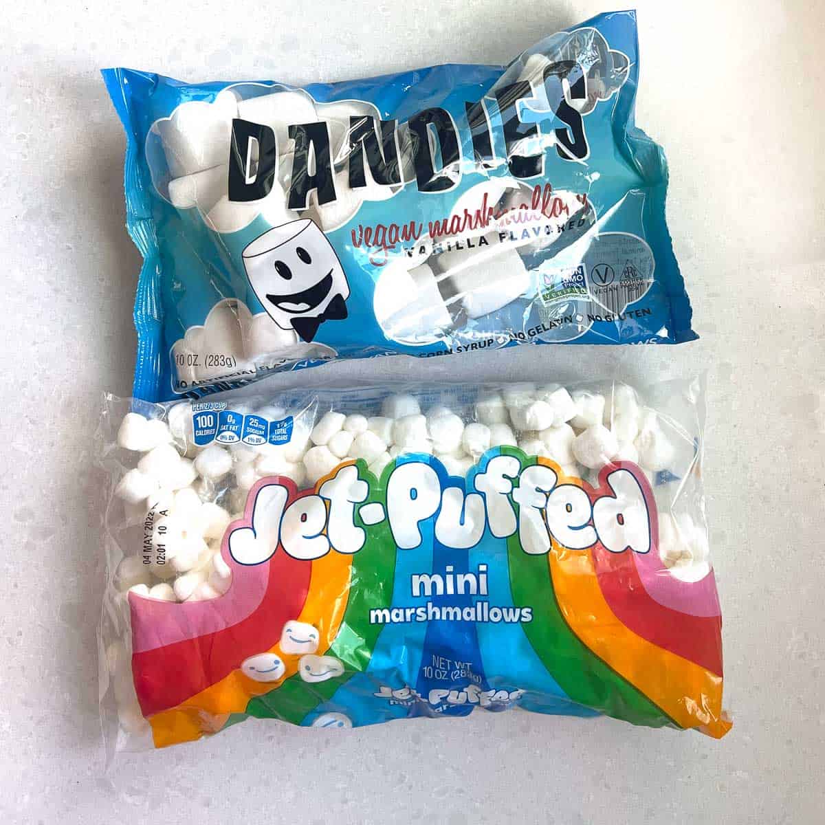 bag of dandies and jet puffed marshmallows on white background