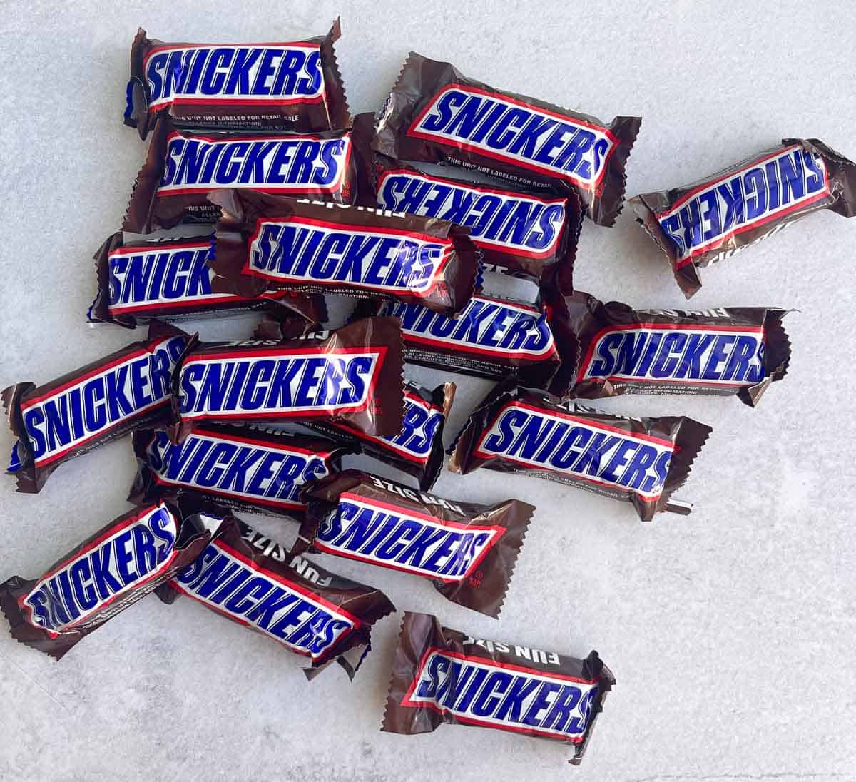 overhead shot of mini snickers bars on counter