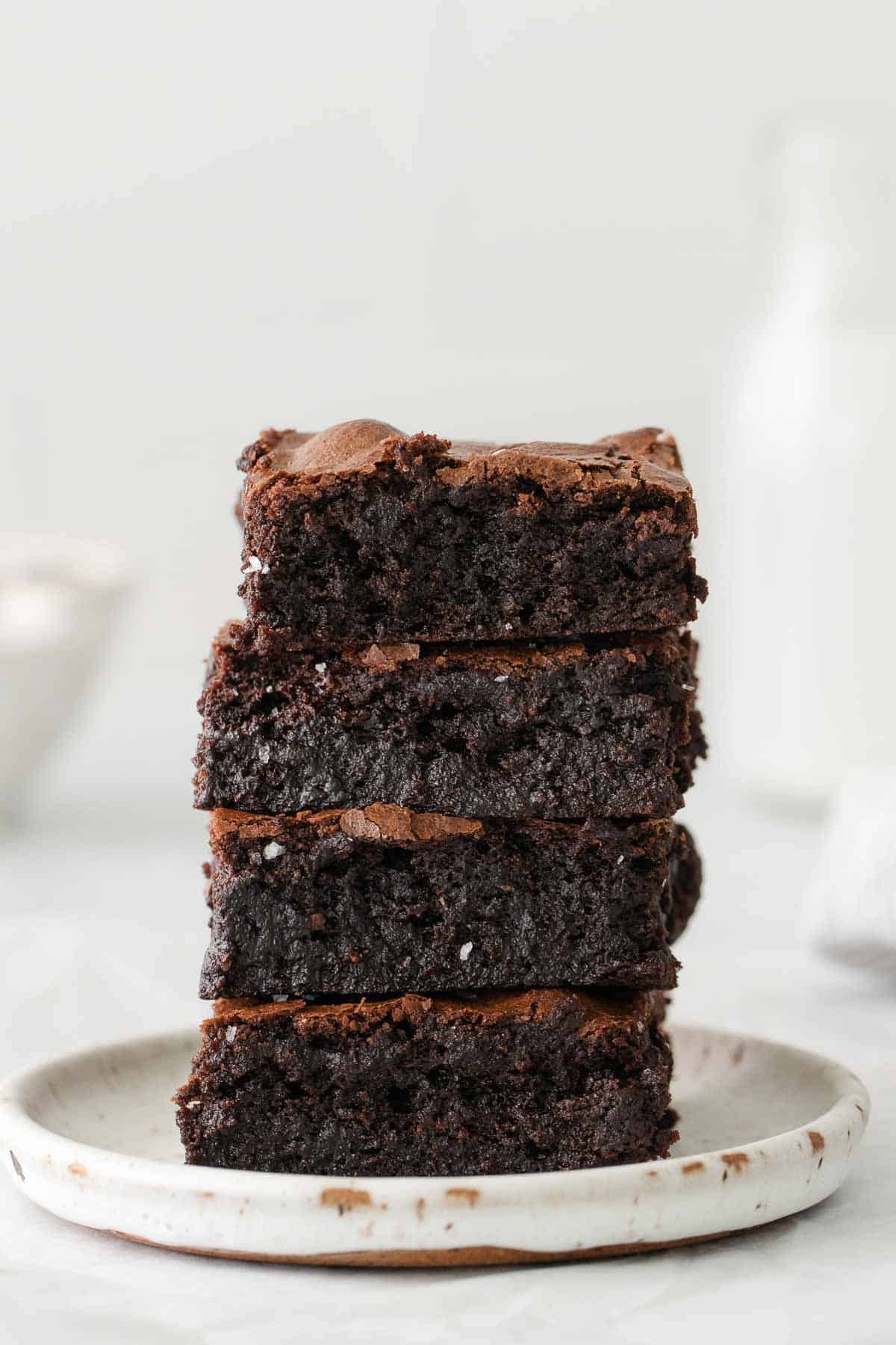 stack of gluten free brownies on white plate