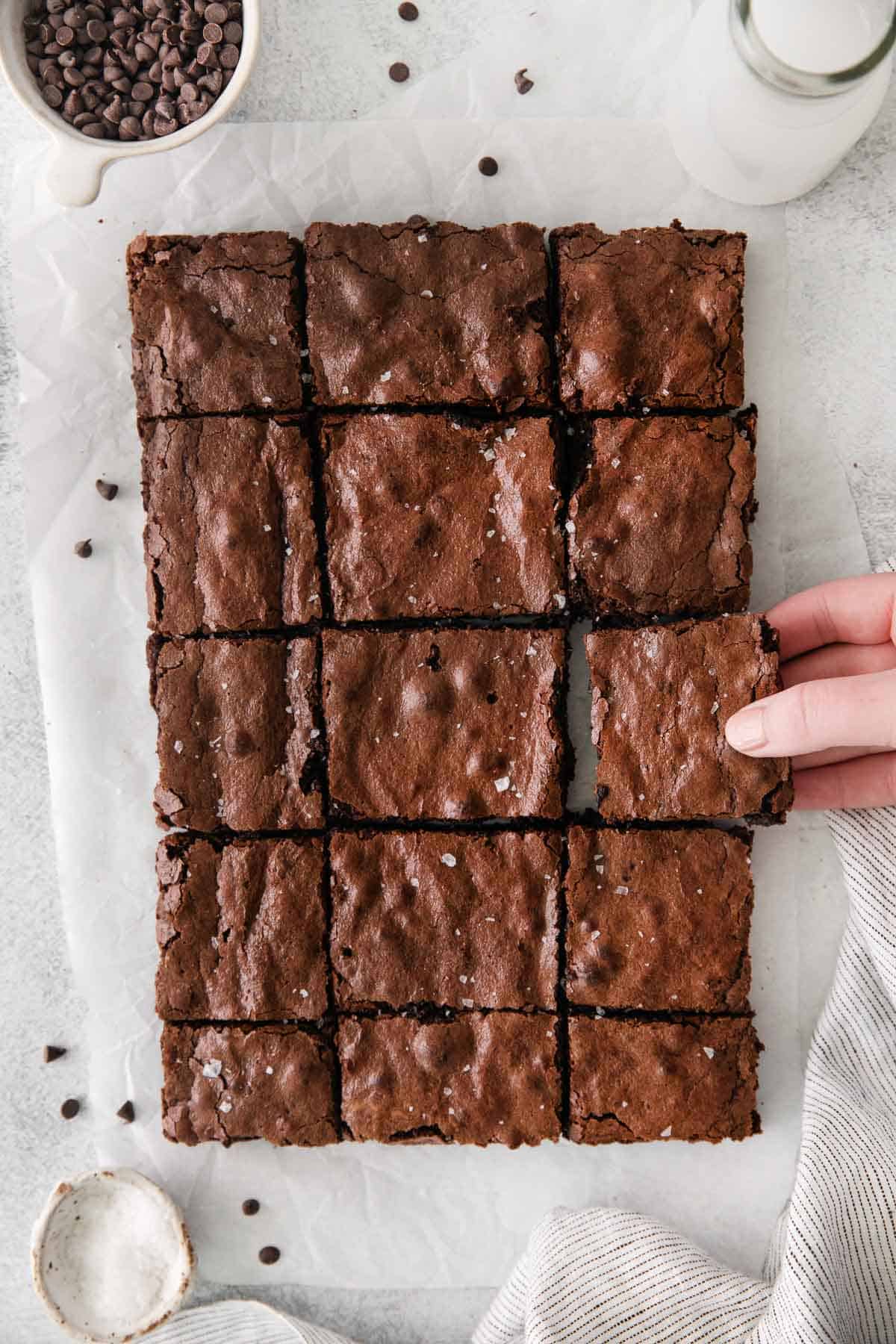 sliced pan of brownies on white parchment paper