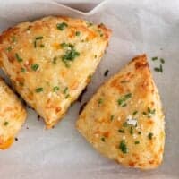 Cheese scones on a baking tray with parchment paper
