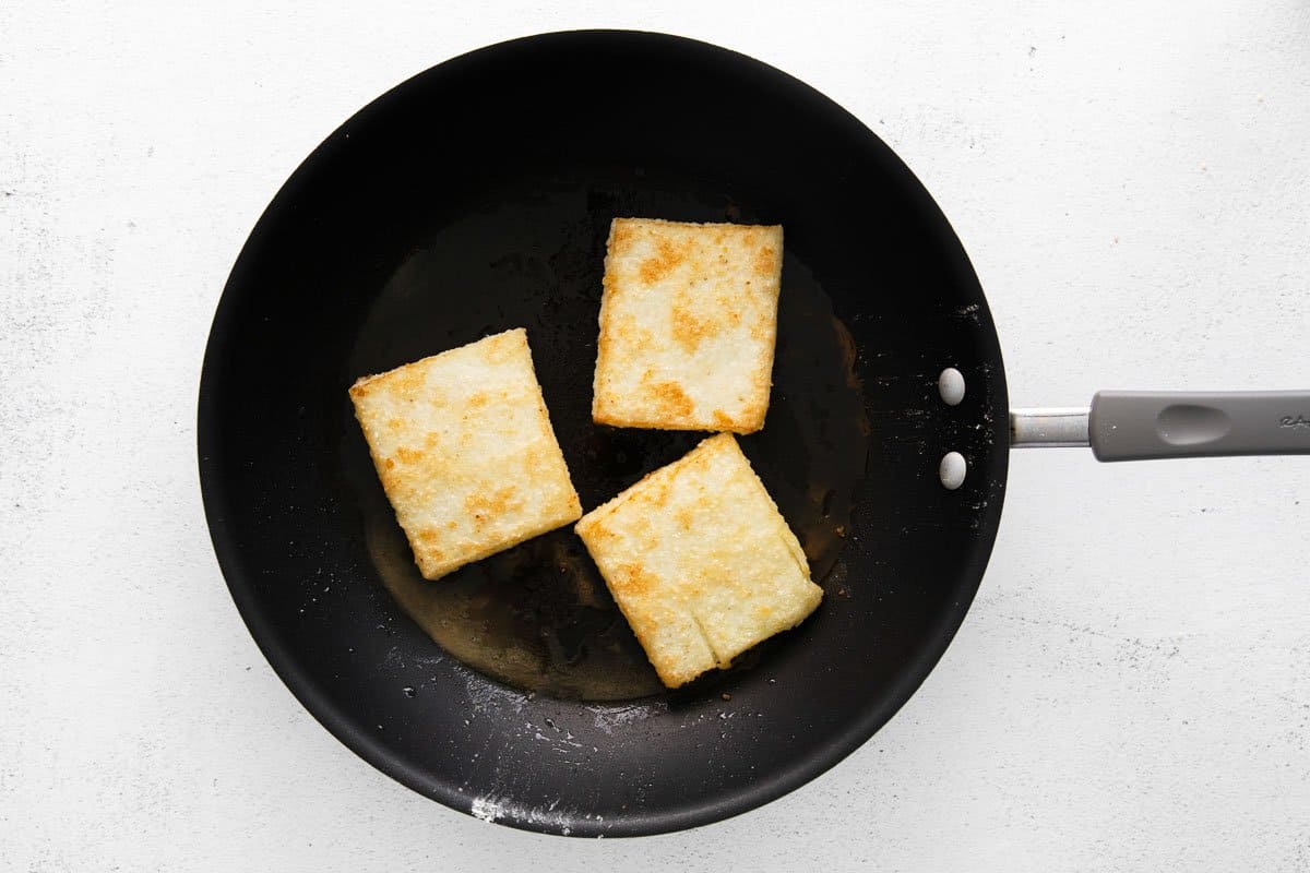 Grit cakes in a skillet