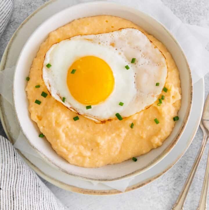Grits and eggs in a bowl on a countertop