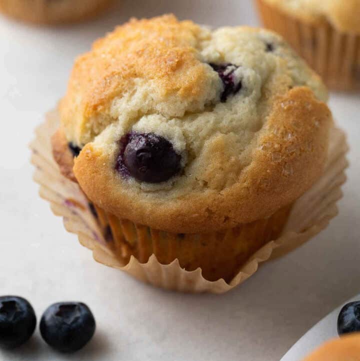 close up shot of blueberry muffin with wrapper peeled open
