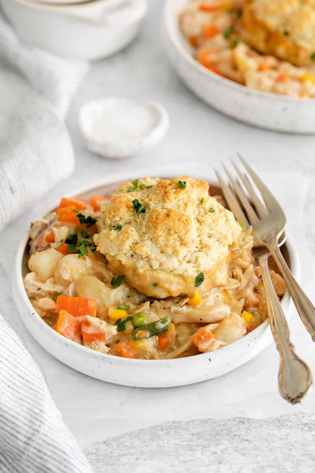 Chicken pot pie dished into a bowl with a fork next to it