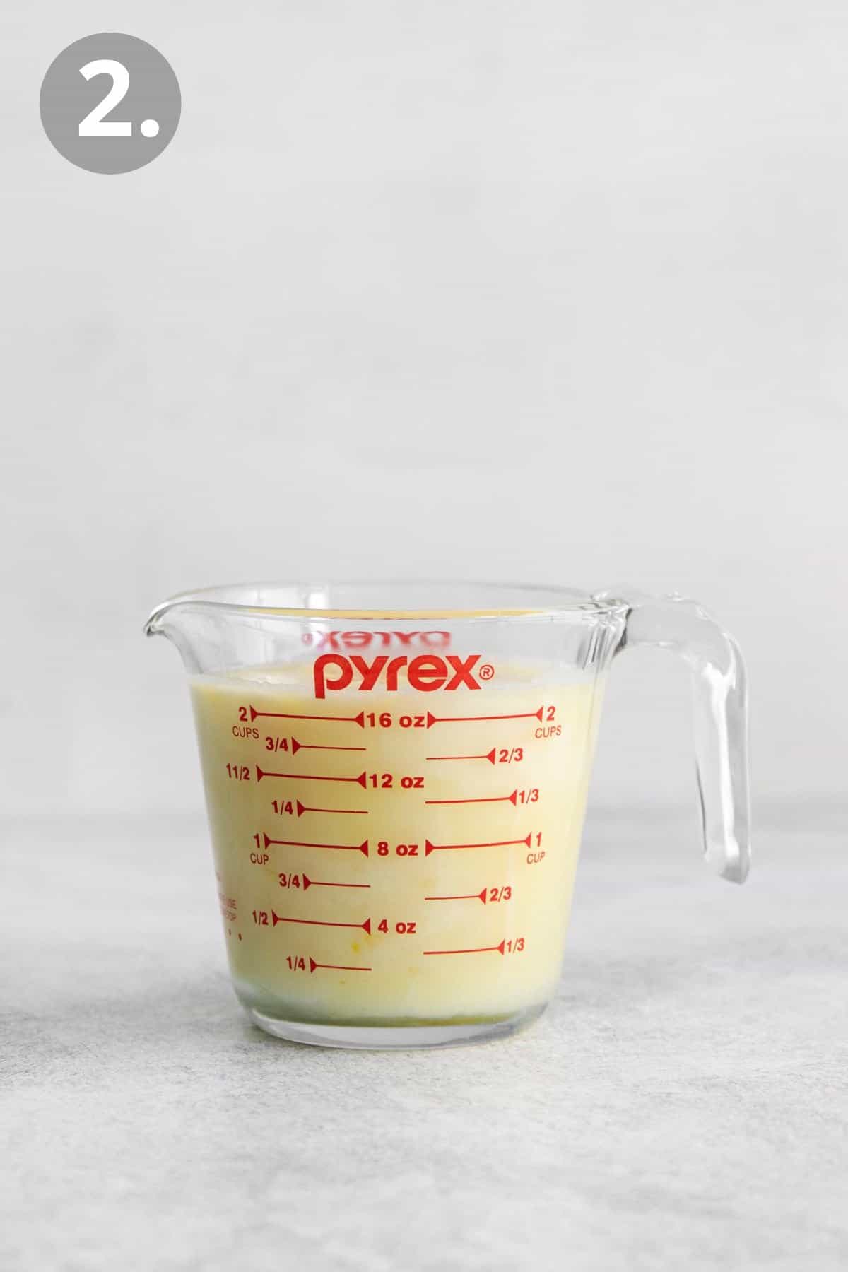 Lemon posset ingredients in a Pyrex measuring cup