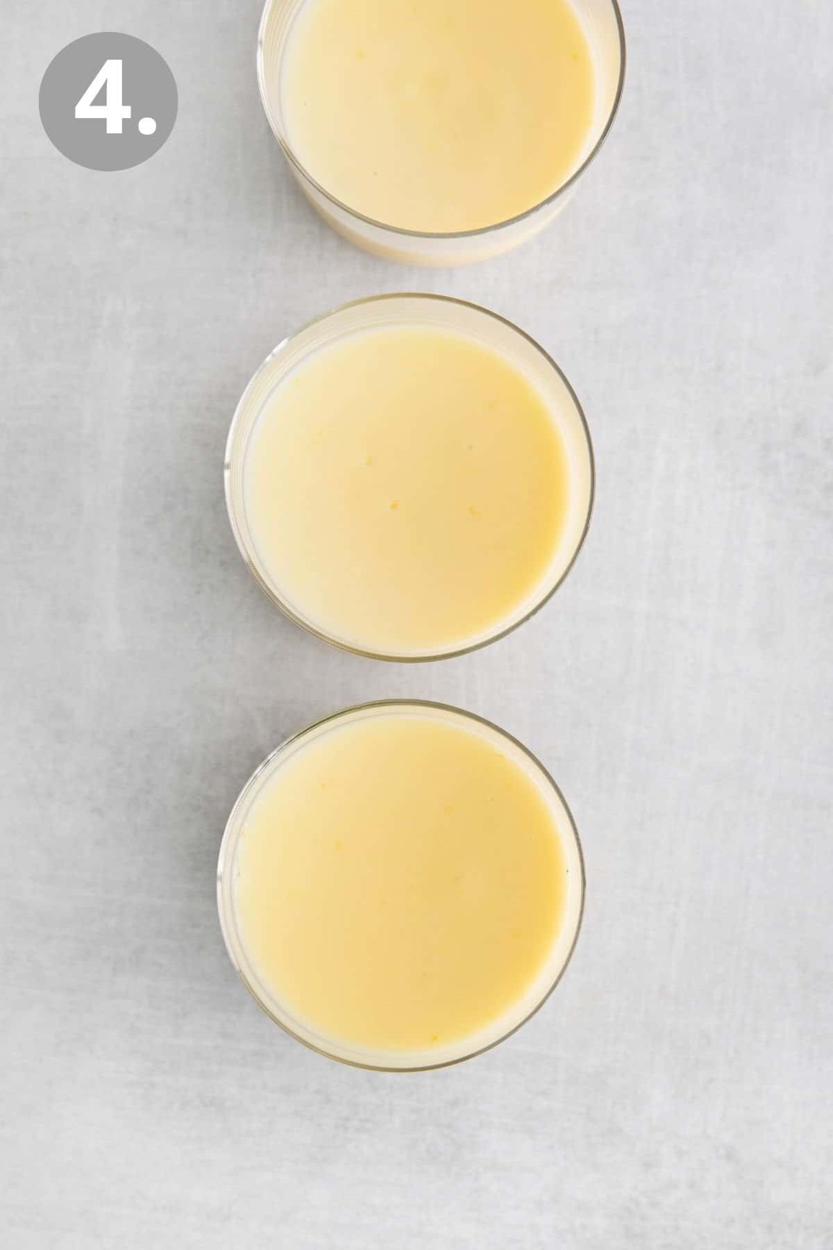 Lemon posset in three individual ramekins on a counter top