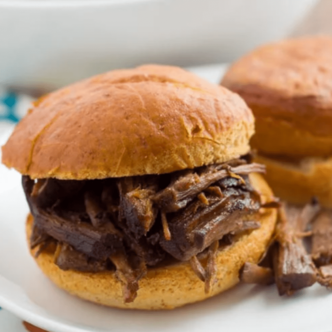Slow-Cooker Balsamic Roast Beef on a bun on a plate