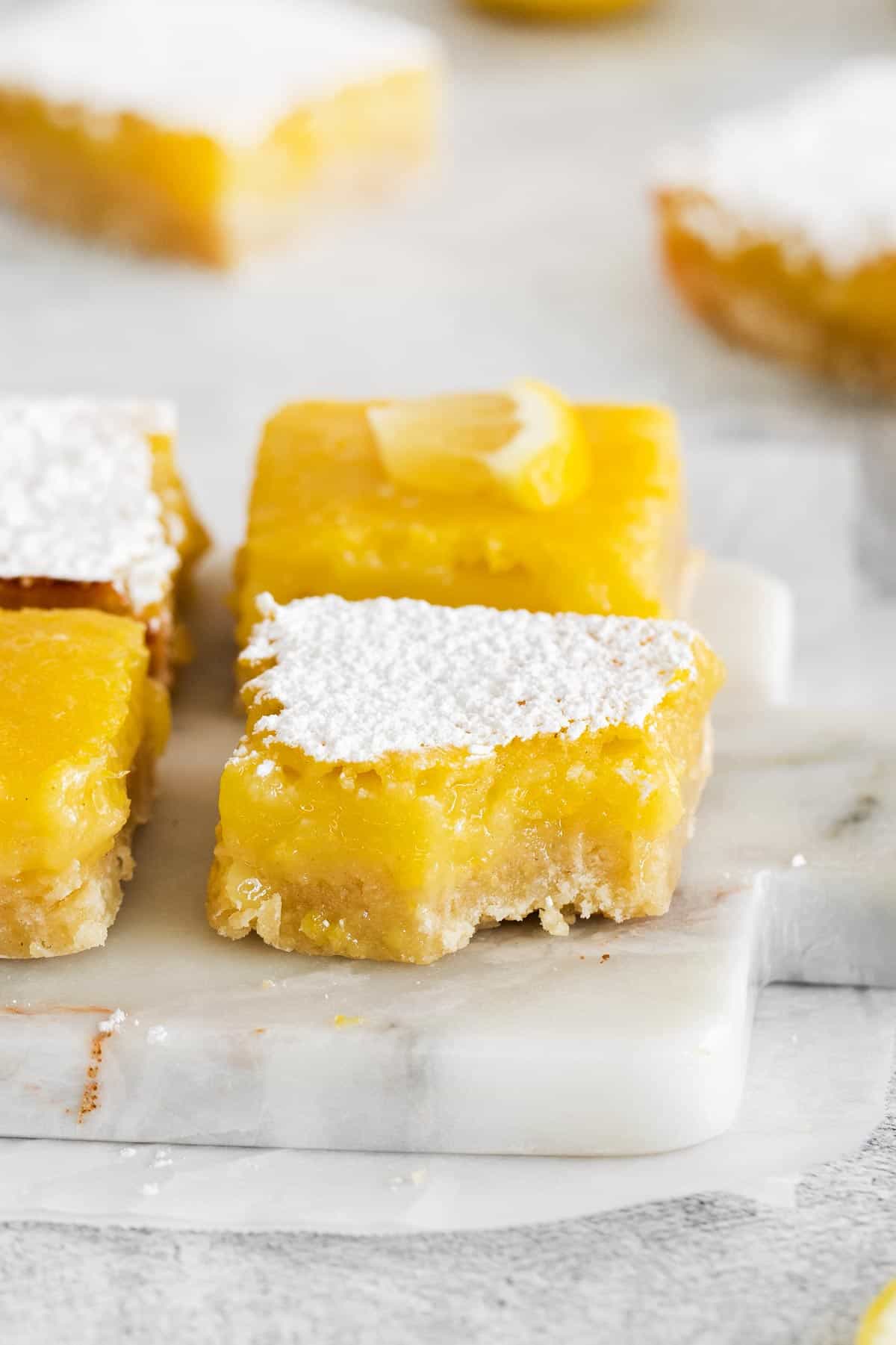 gluten-free lemon bars stacked on a counter top