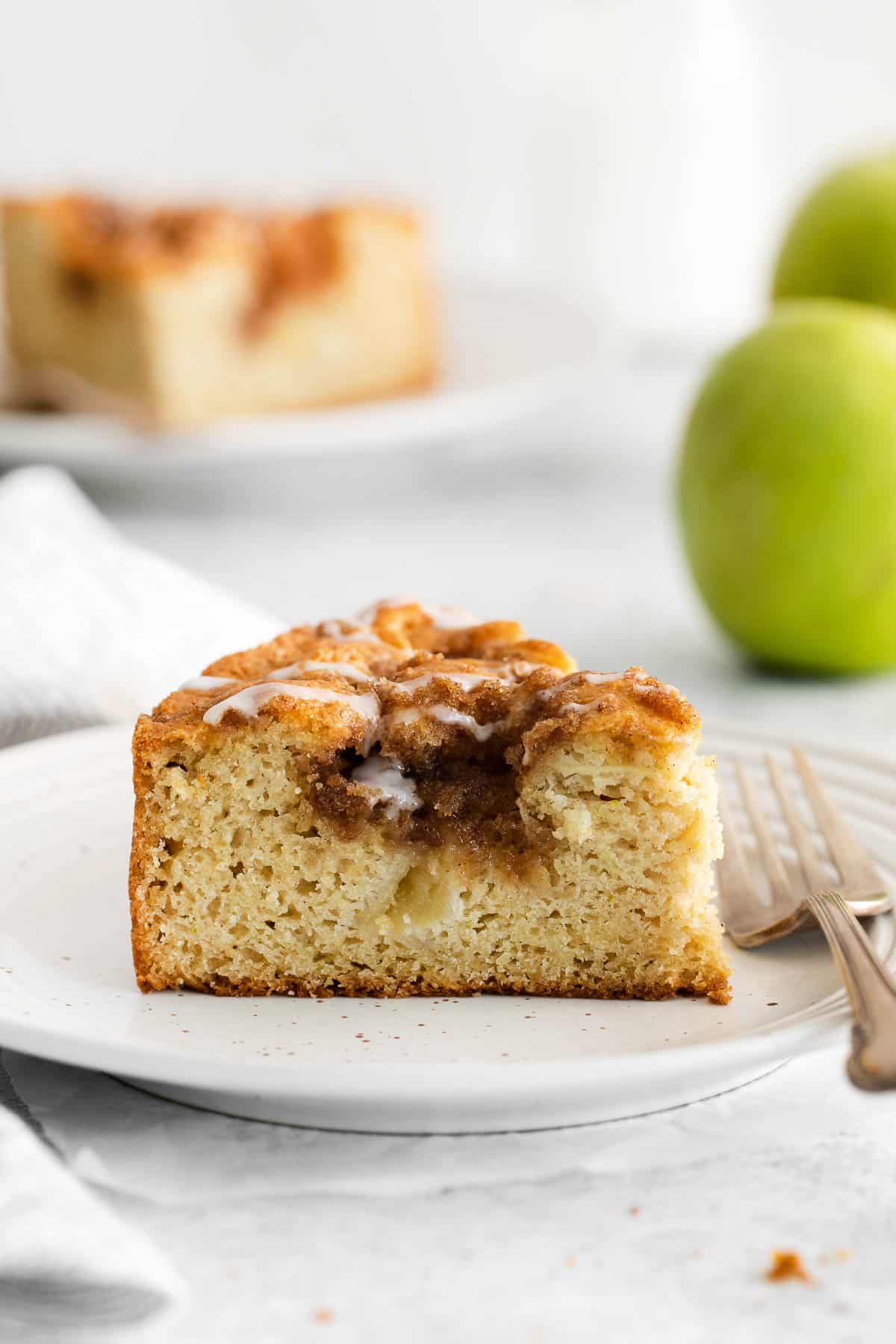 A side view of a slice of apple cake