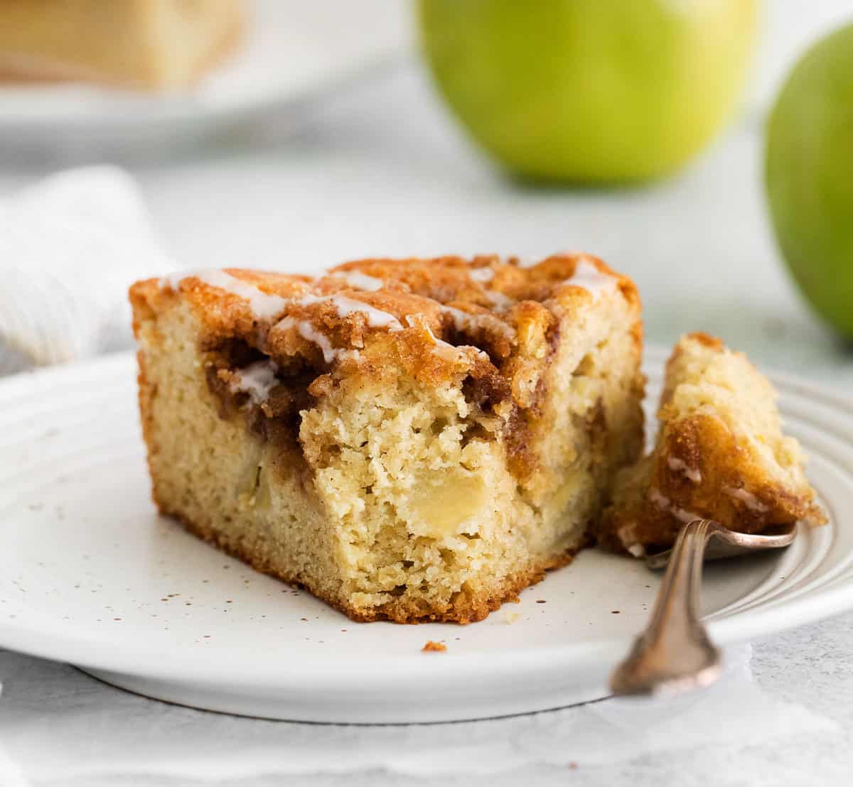 A slice of apple cake with a fork
