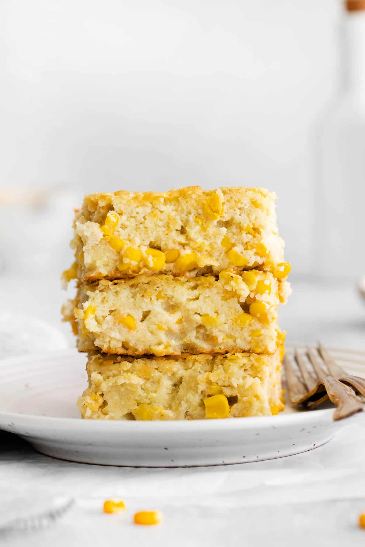 Gluten-free corn casserole slices stacked on a plate
