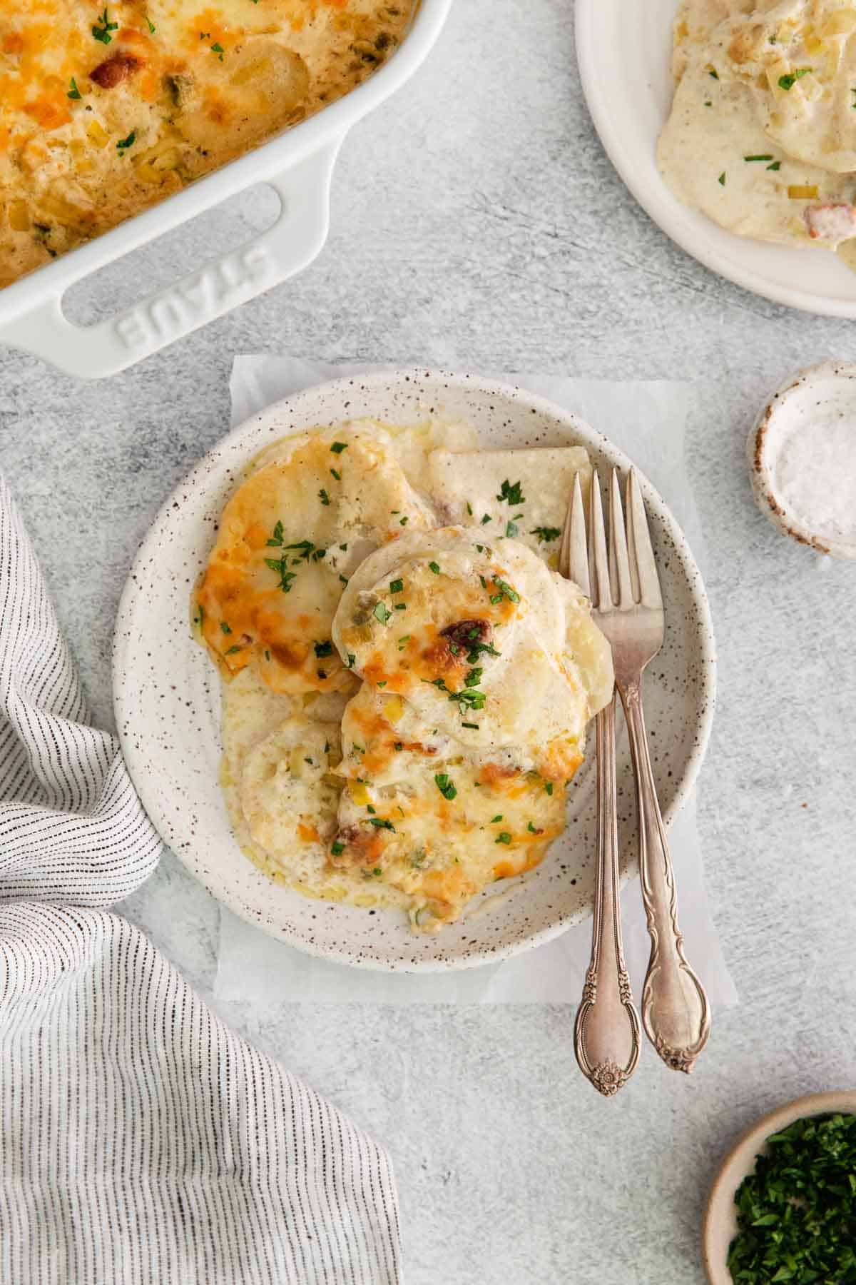 Scalloped potatoes on a plate with a fork