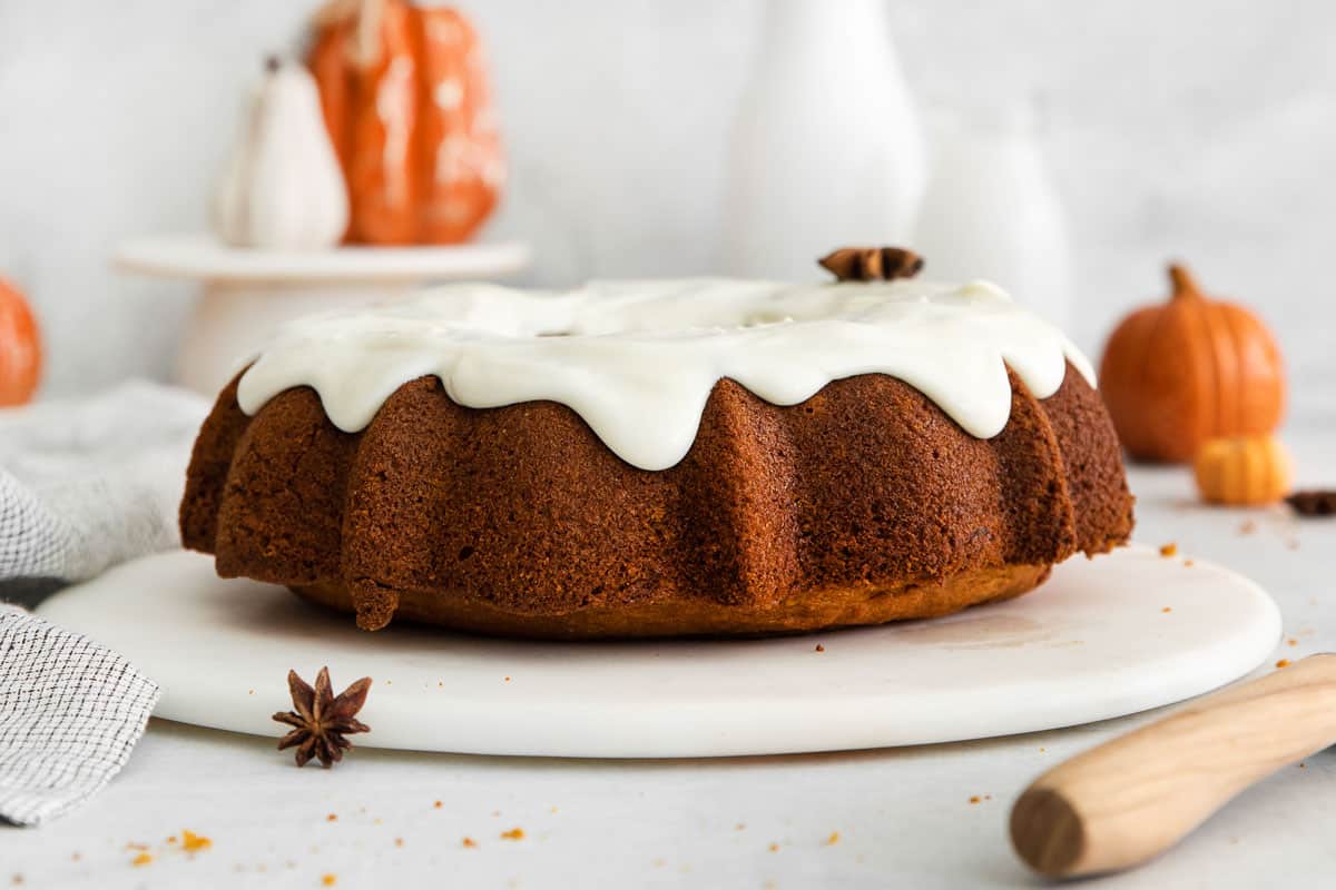 A side view of a frosted gluten-free pumpkin cake