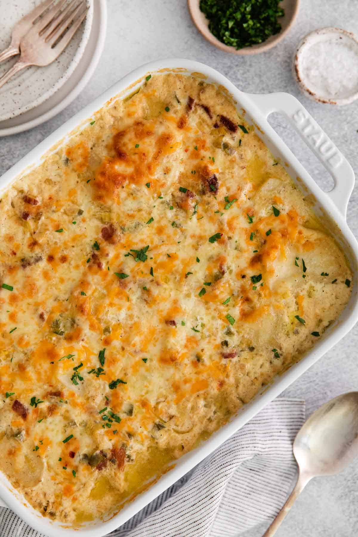 An overhead photo of scalloped potatoes in a baking dish