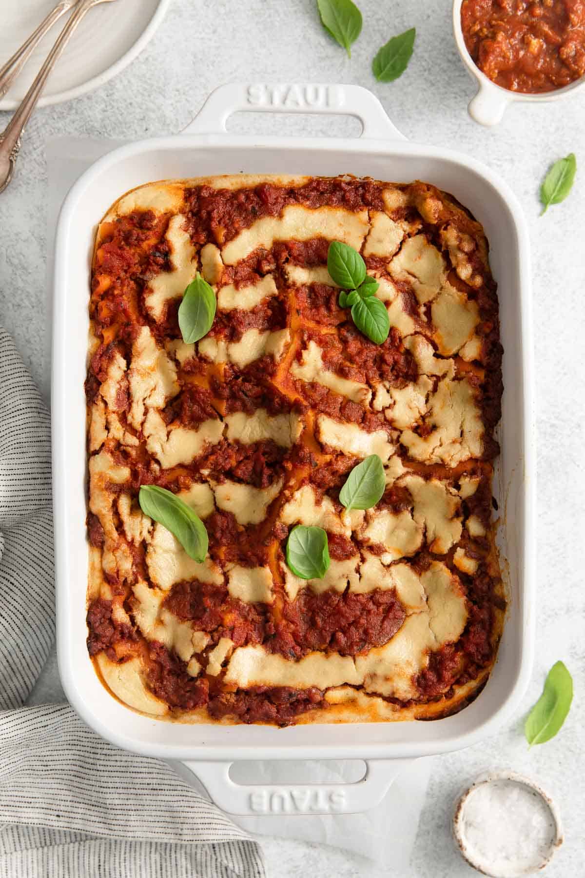 An overhead view of dairy-free lasagna in a baking dish