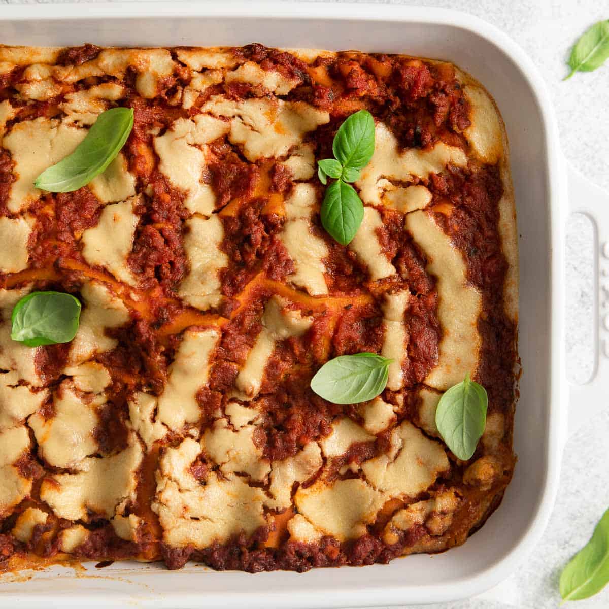 A close-up of dairy-free lasagna in a baking dish