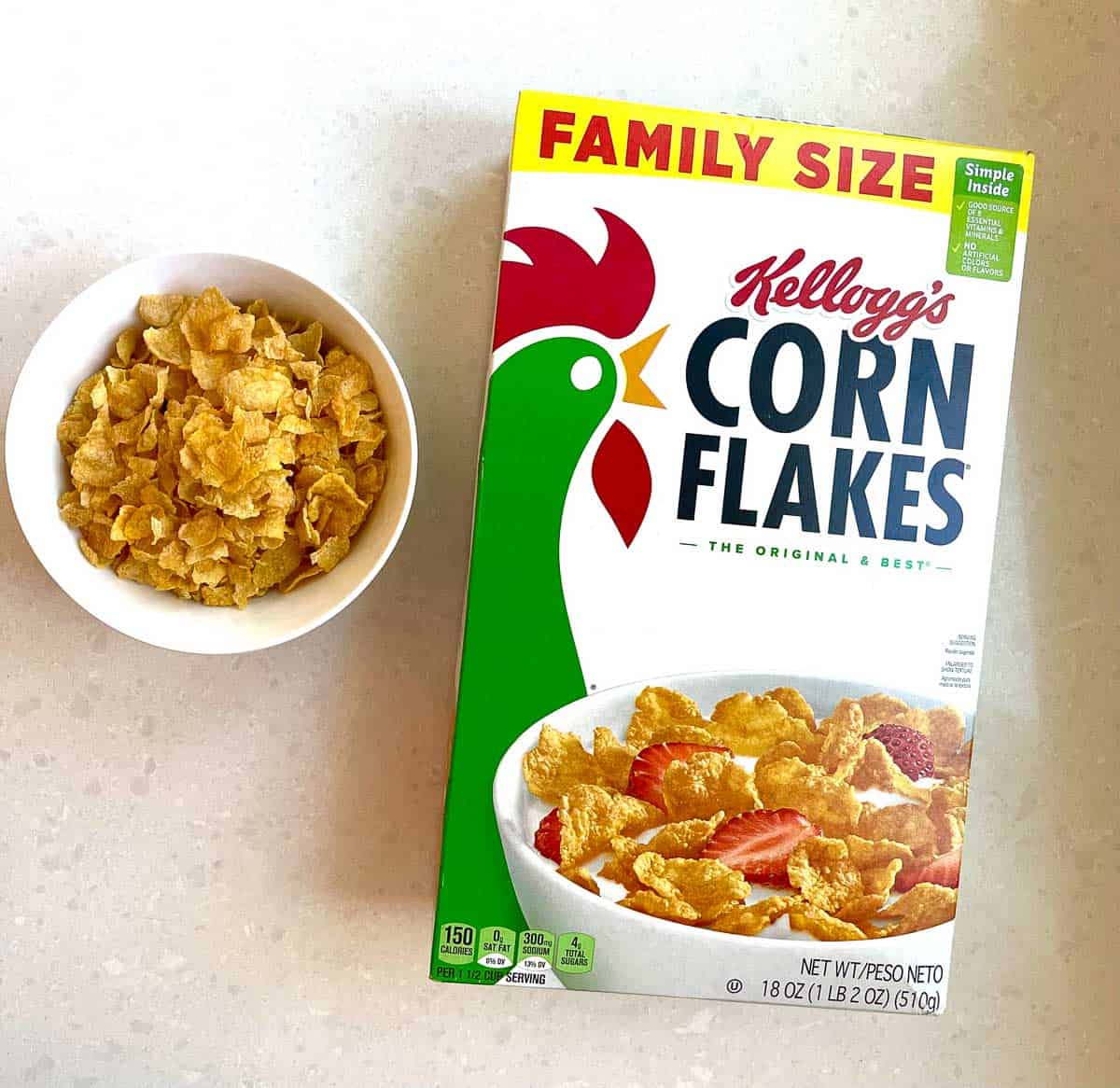 bowl of corn flakes next to box of cornflakes