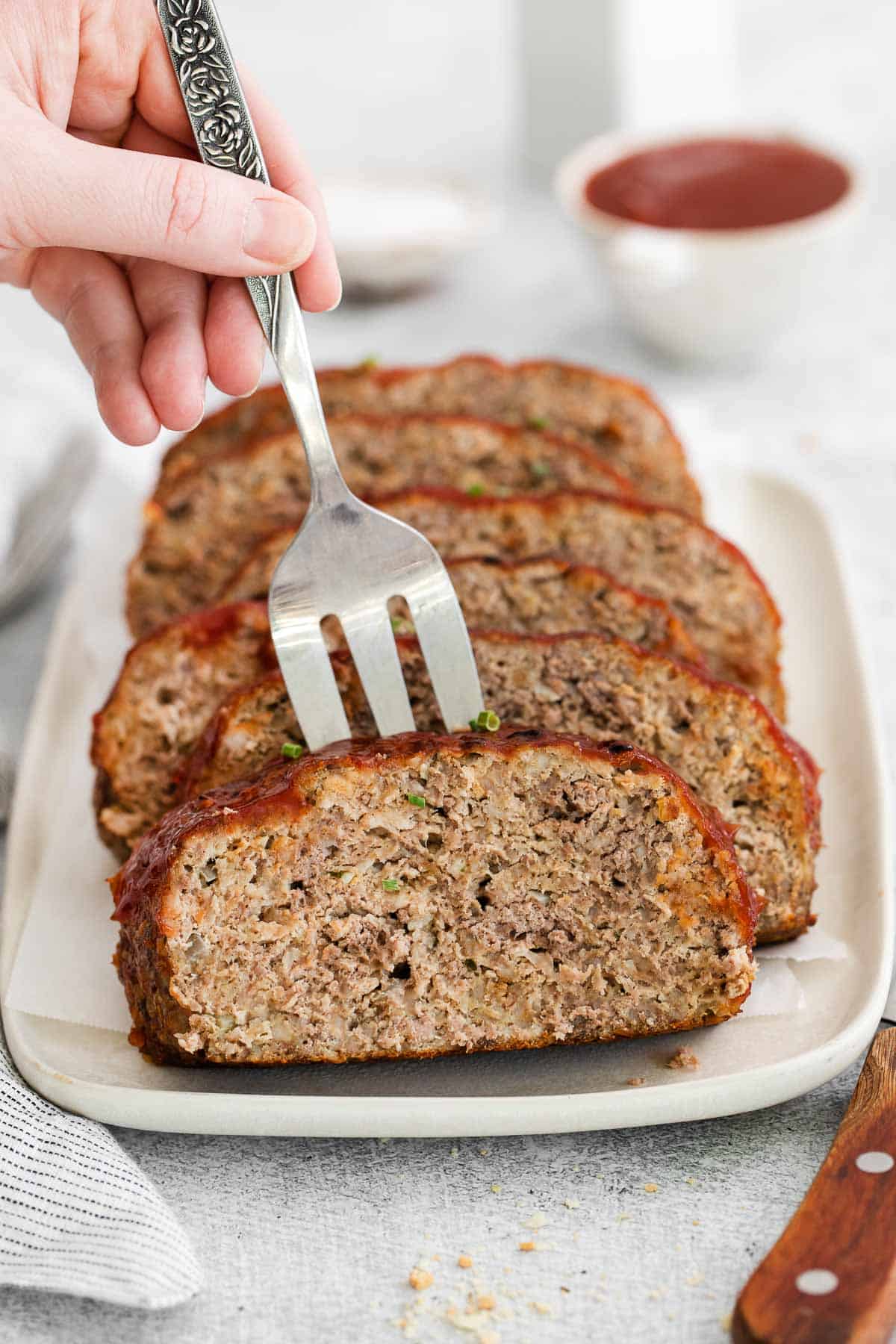 A serving fork picking up a slice of gluten-free meatloaf