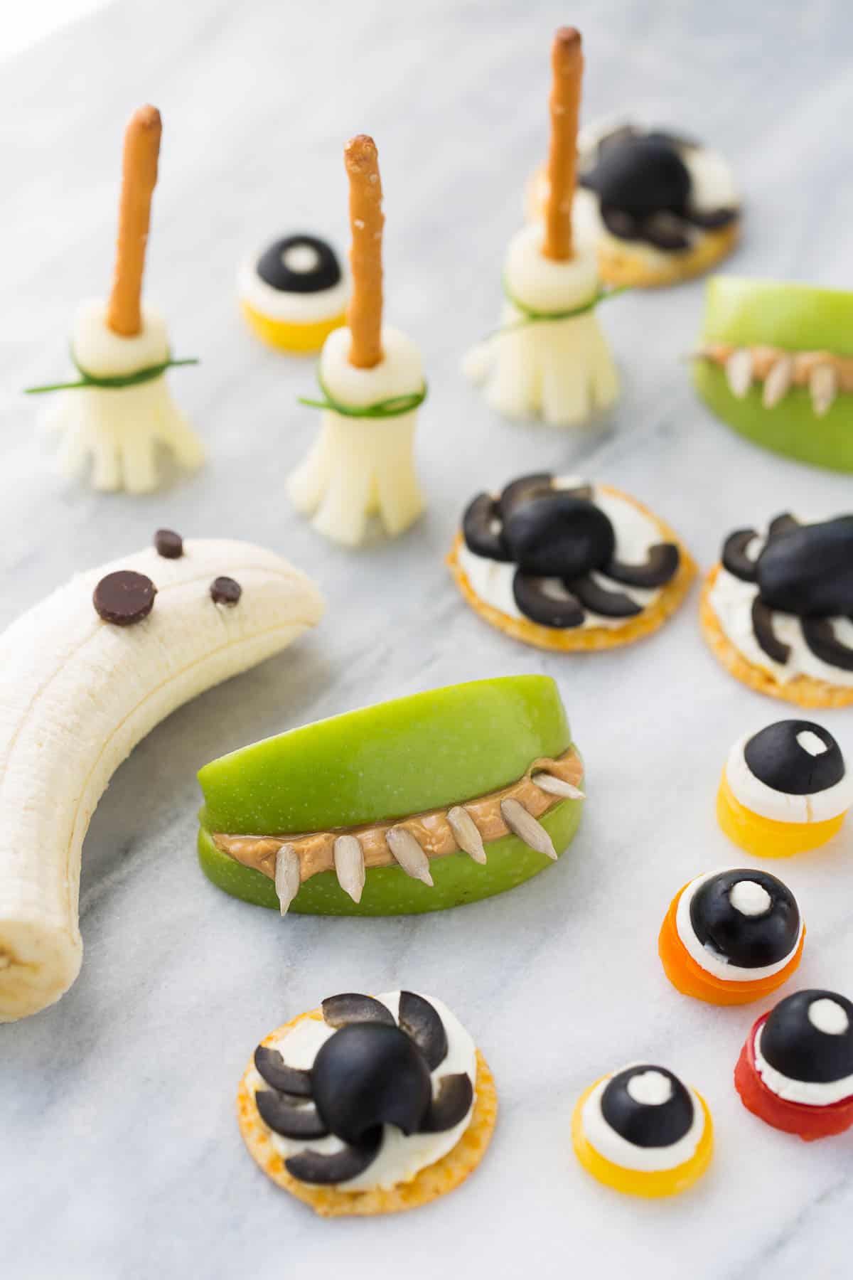 healthy halloween snacks on white marble background