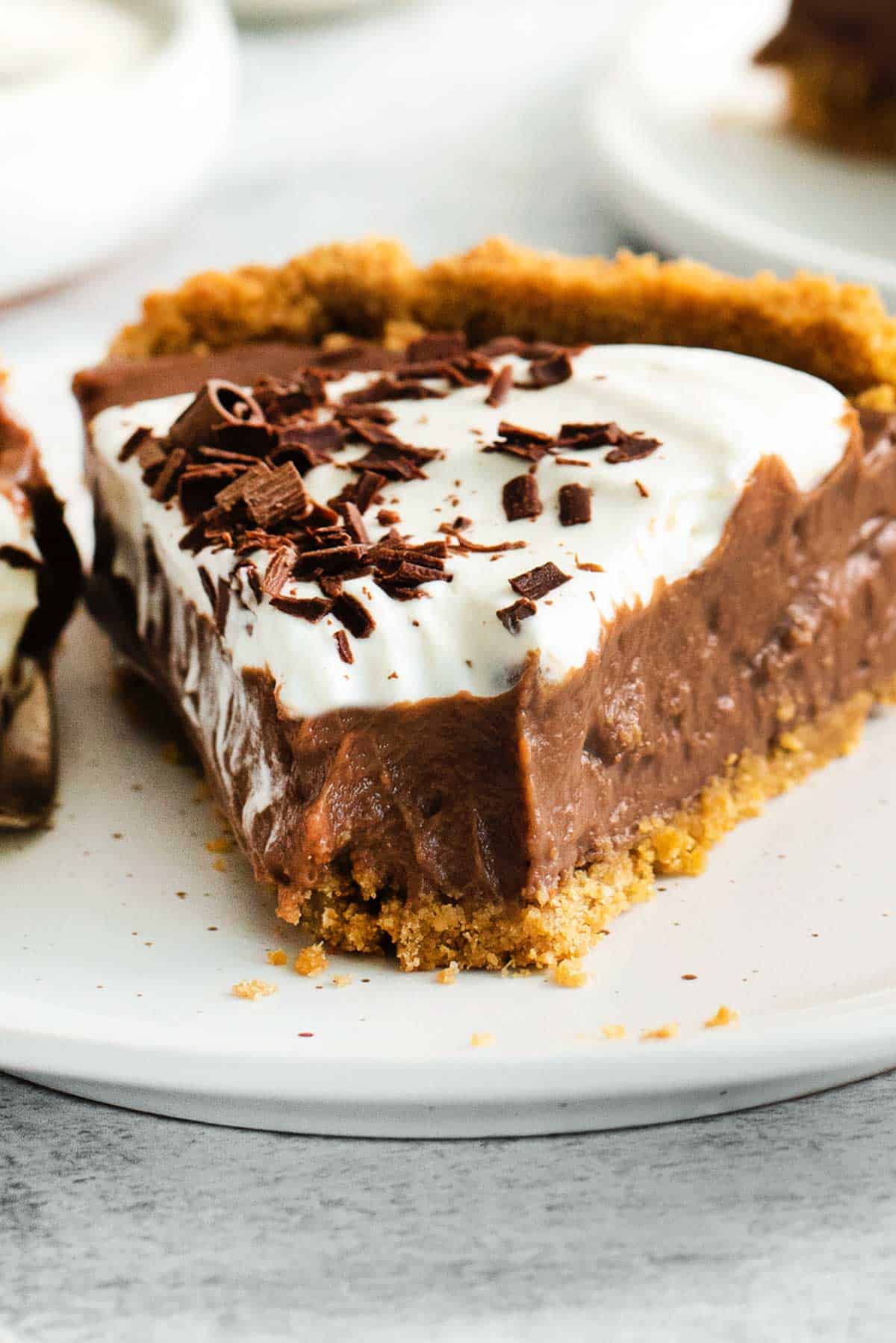 A slice of chocolate pie with a bite taken out of it