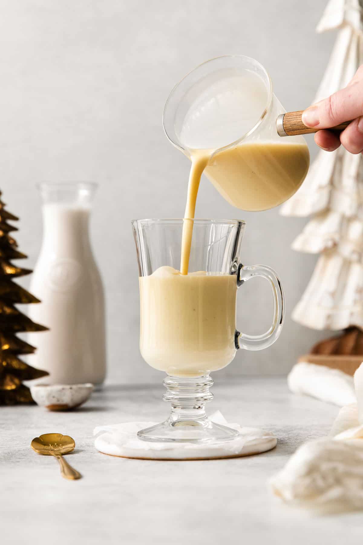 Egg nog being poured in a glass
