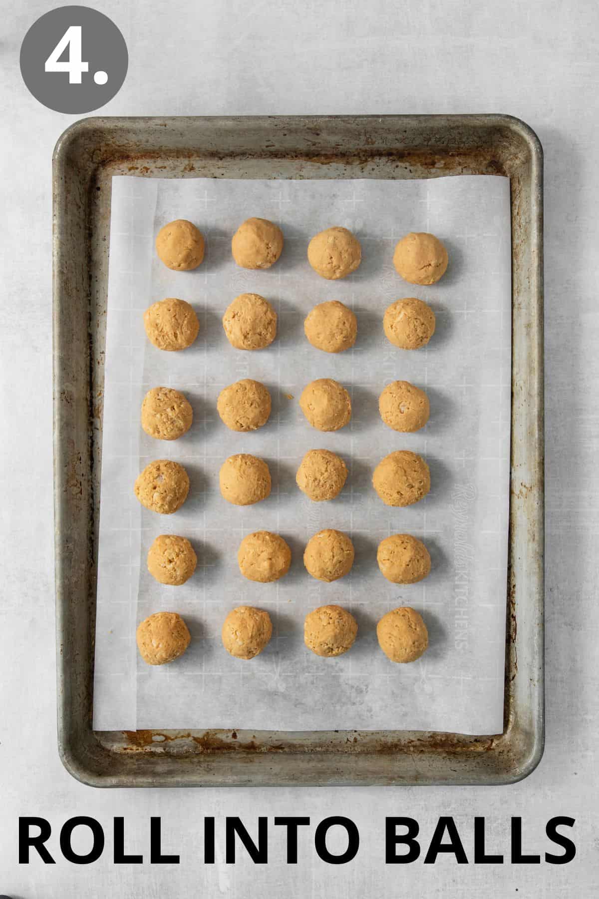 Peanut butter cookie dough rolled into balls on a baking sheet