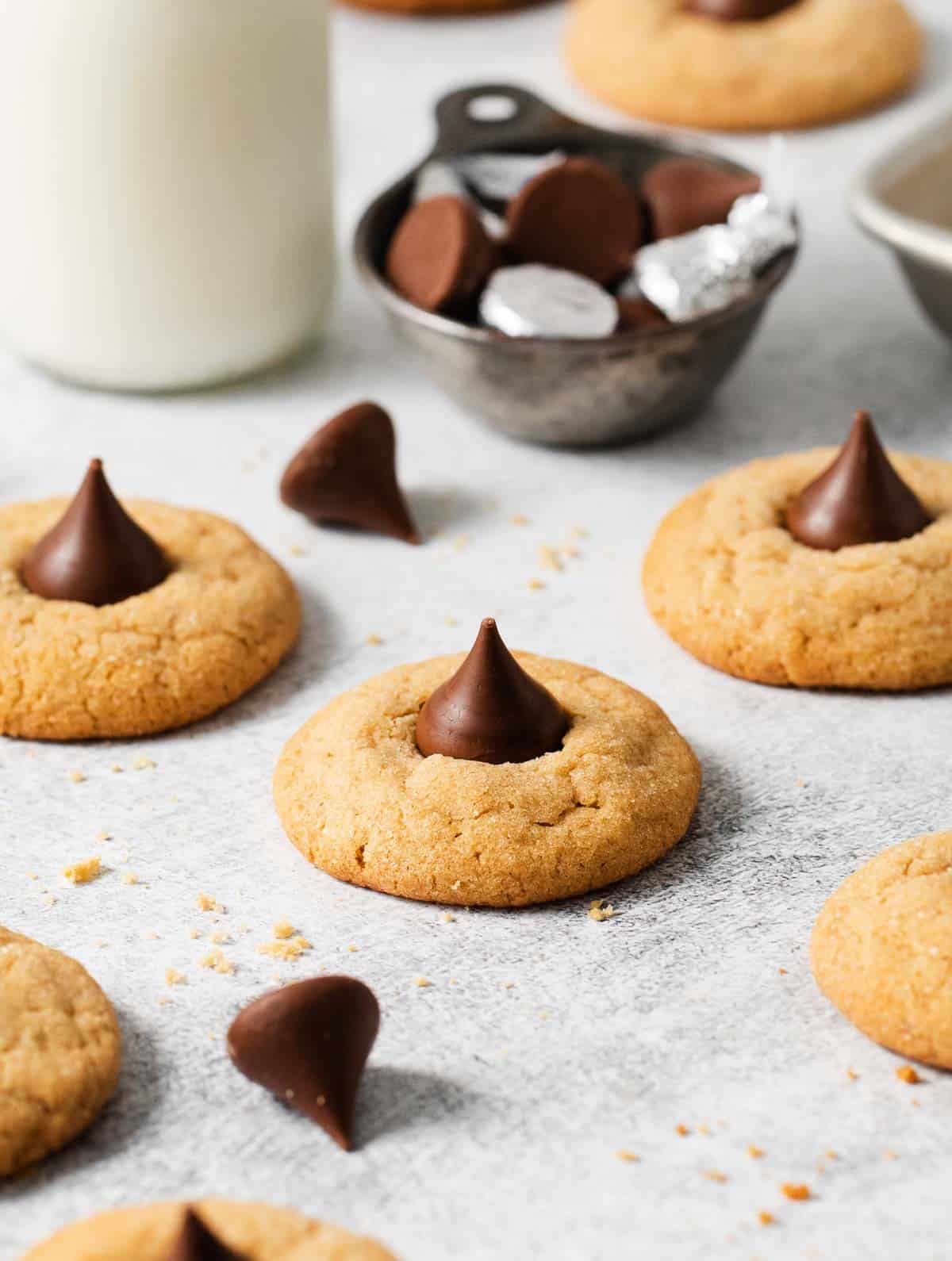 Gluten-free peanut butter blossoms spread out on a counter top