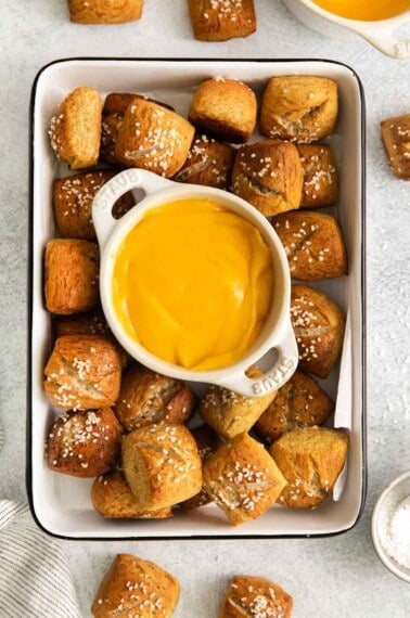 pretzels in a serving dish with cheese sauce in the middle