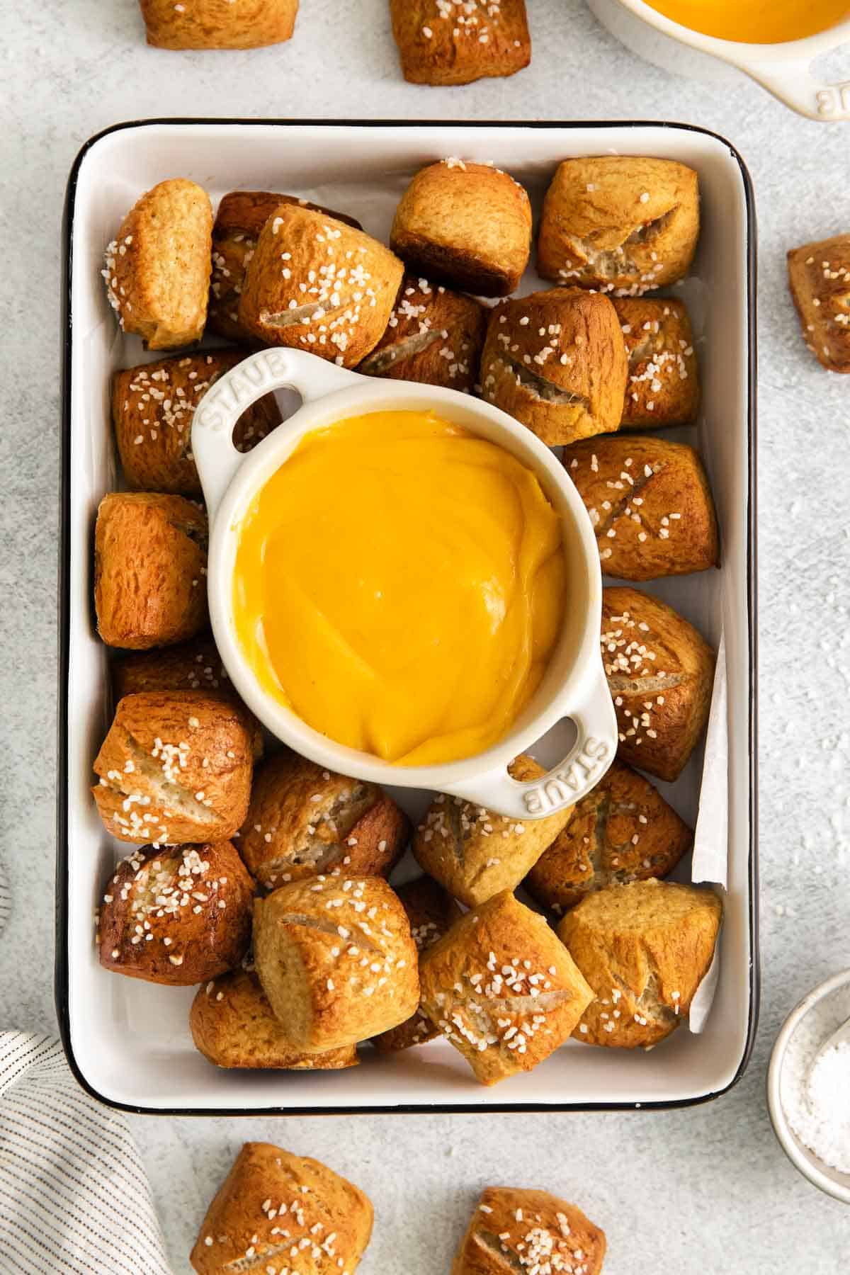 pretzels in a serving dish with cheese sauce in the middle