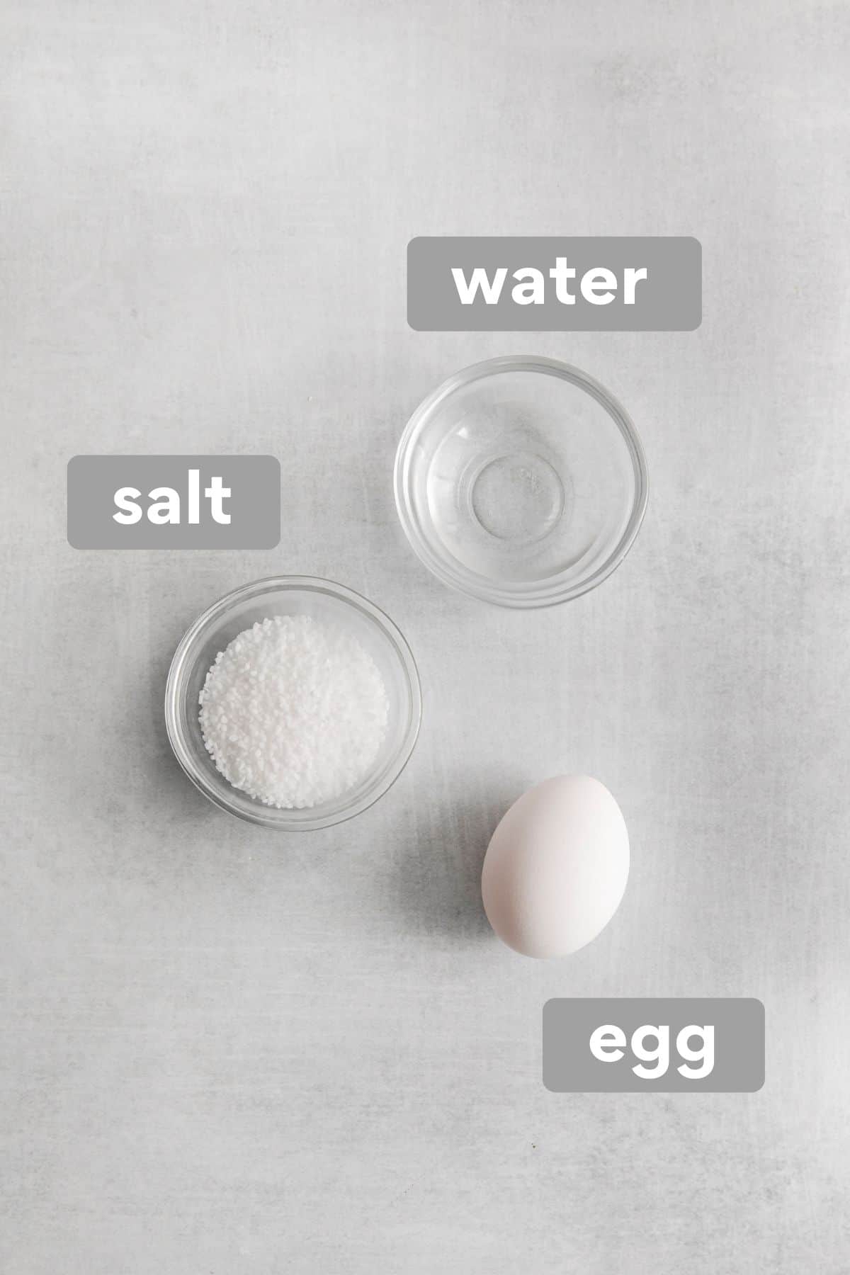 Egg, salt, and water on a counter top