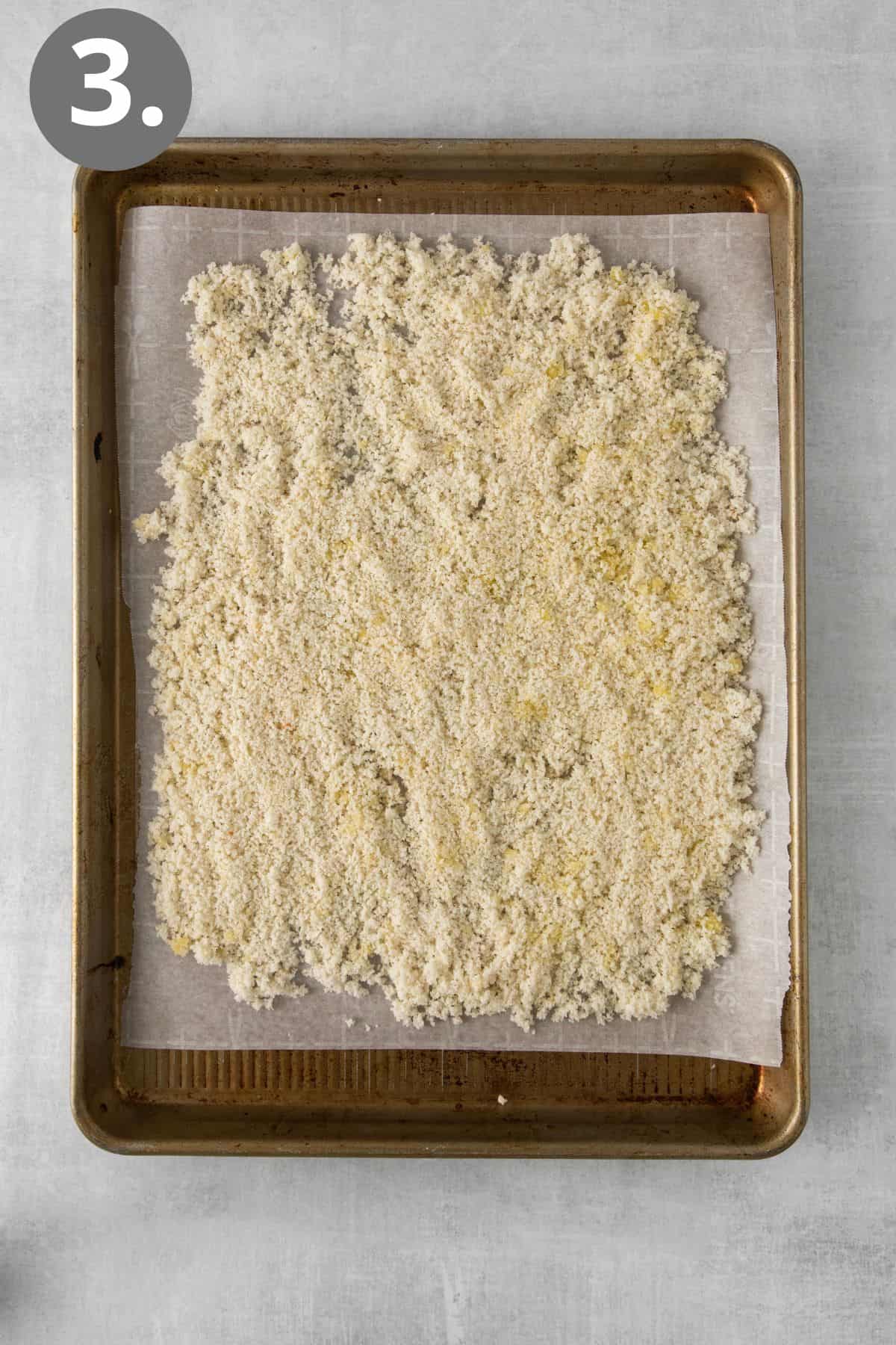 Gluten-free breadcrumbs on a baking sheet before baking