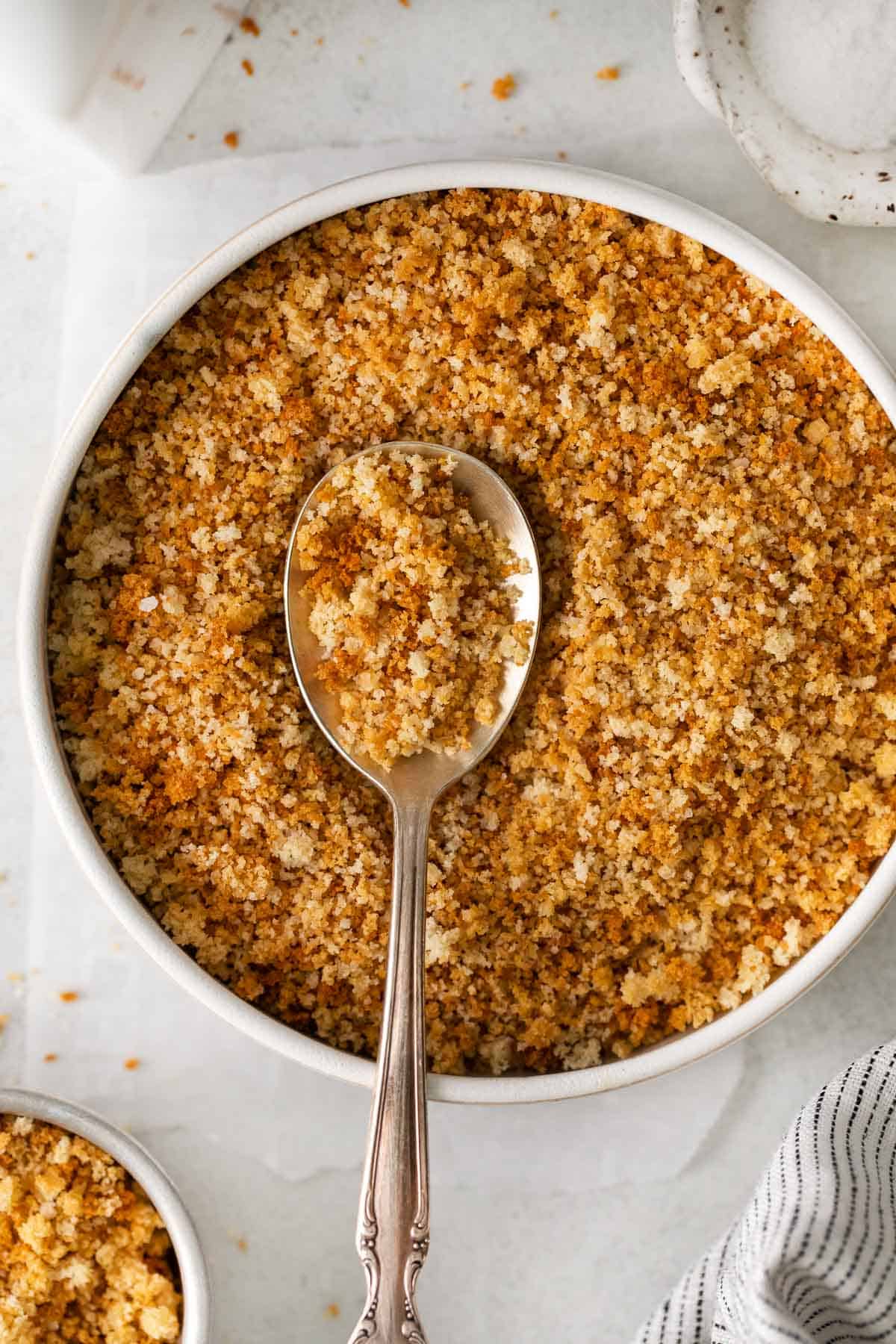 Gluten-free breadcrumbs in a bowl with a spoon
