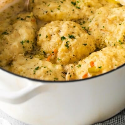 A close-up photo of chicken and dumplings in a baking dish