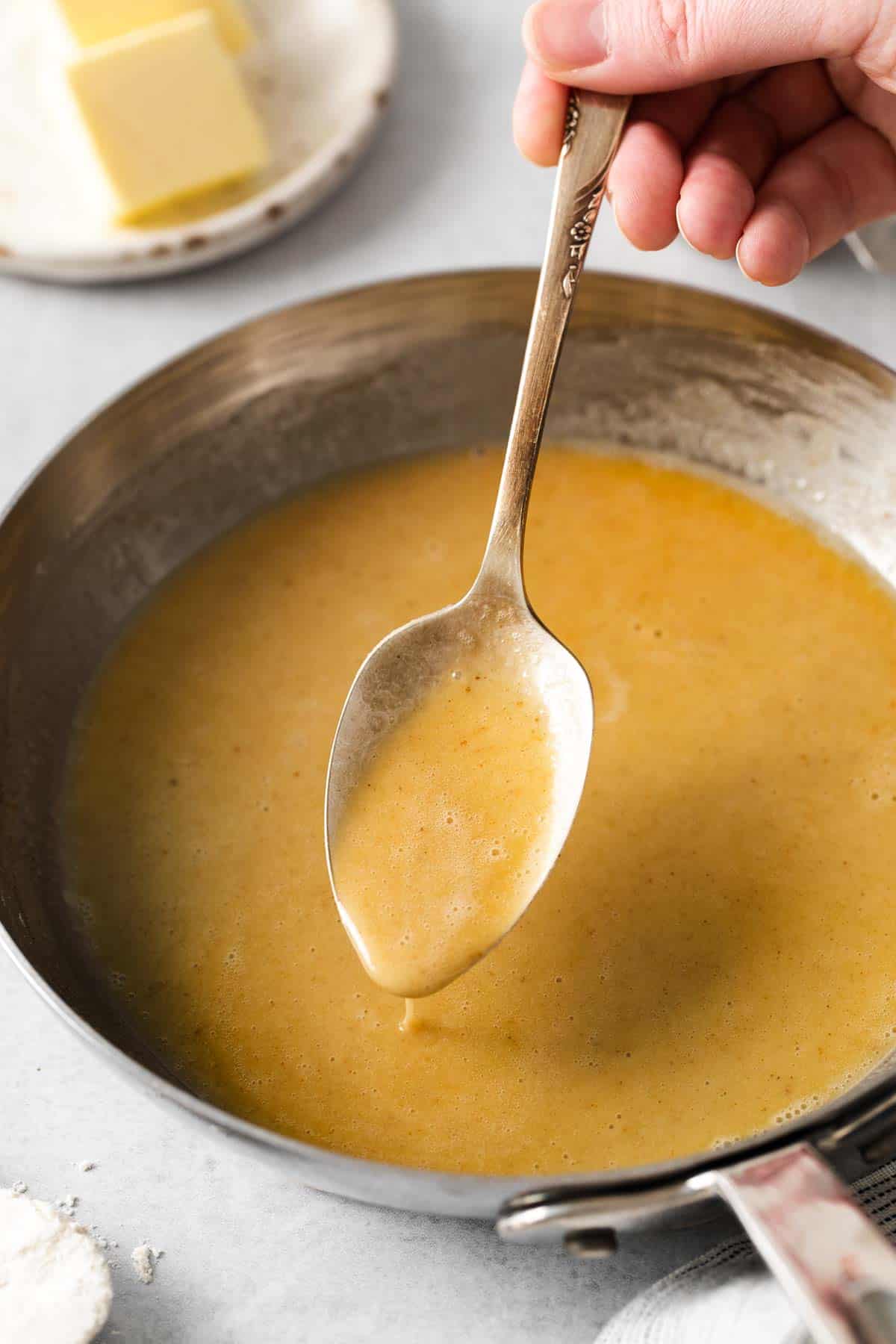 Gluten-free roux in a skillet with a spoon