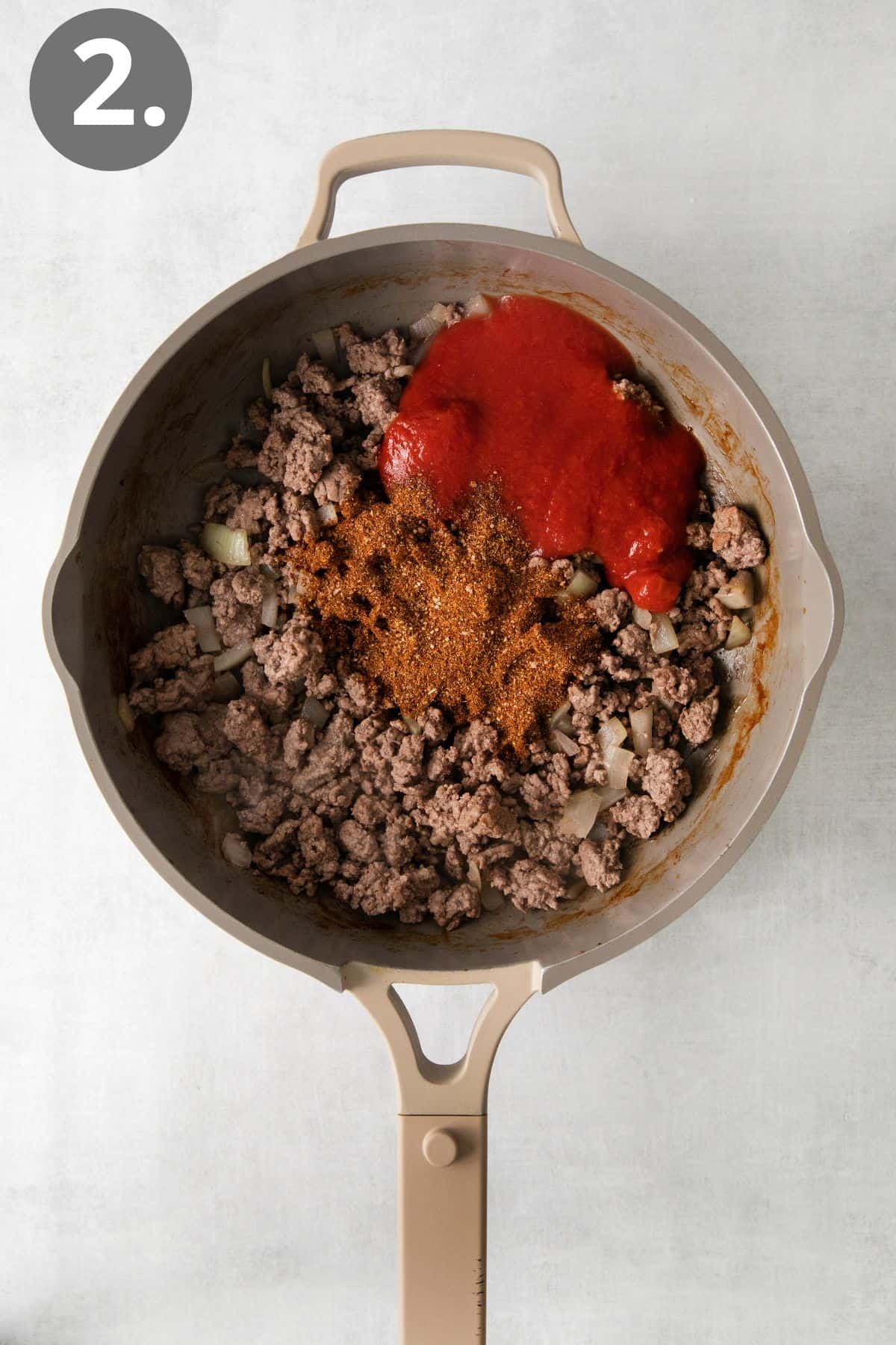 Ground beef and seasoning in a skillet