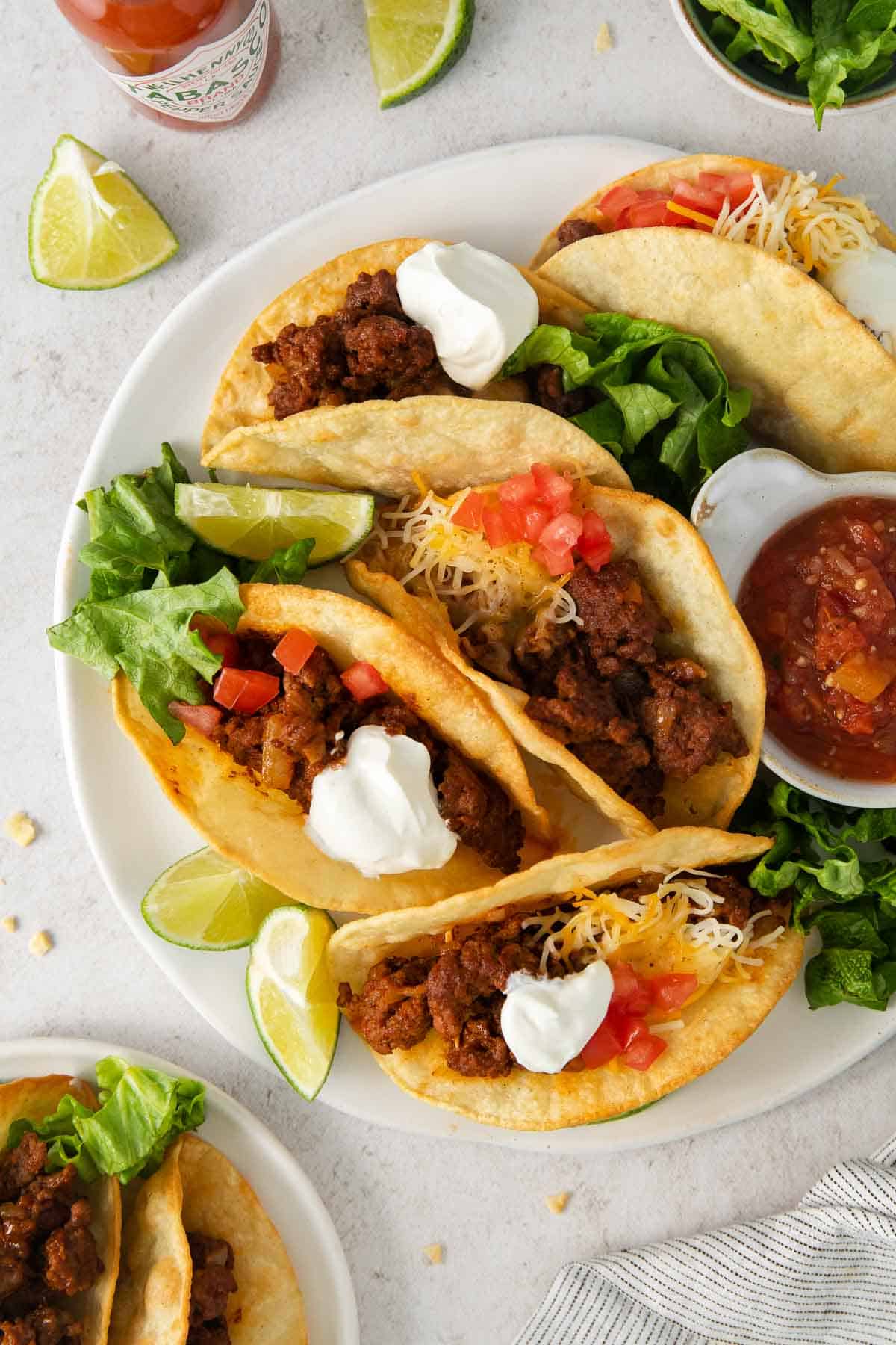 Gluten-free tacos on a plate with toppings