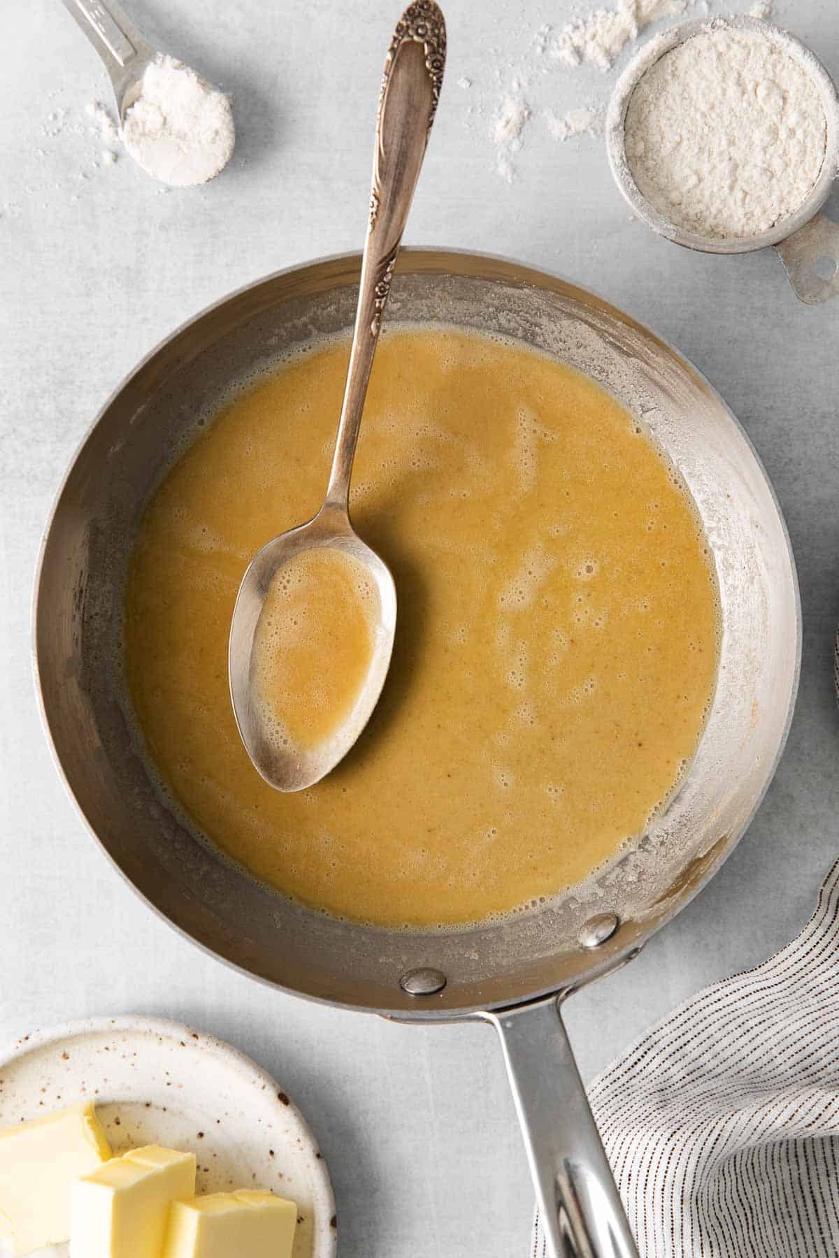 An overview of roux in a pan with a spoon